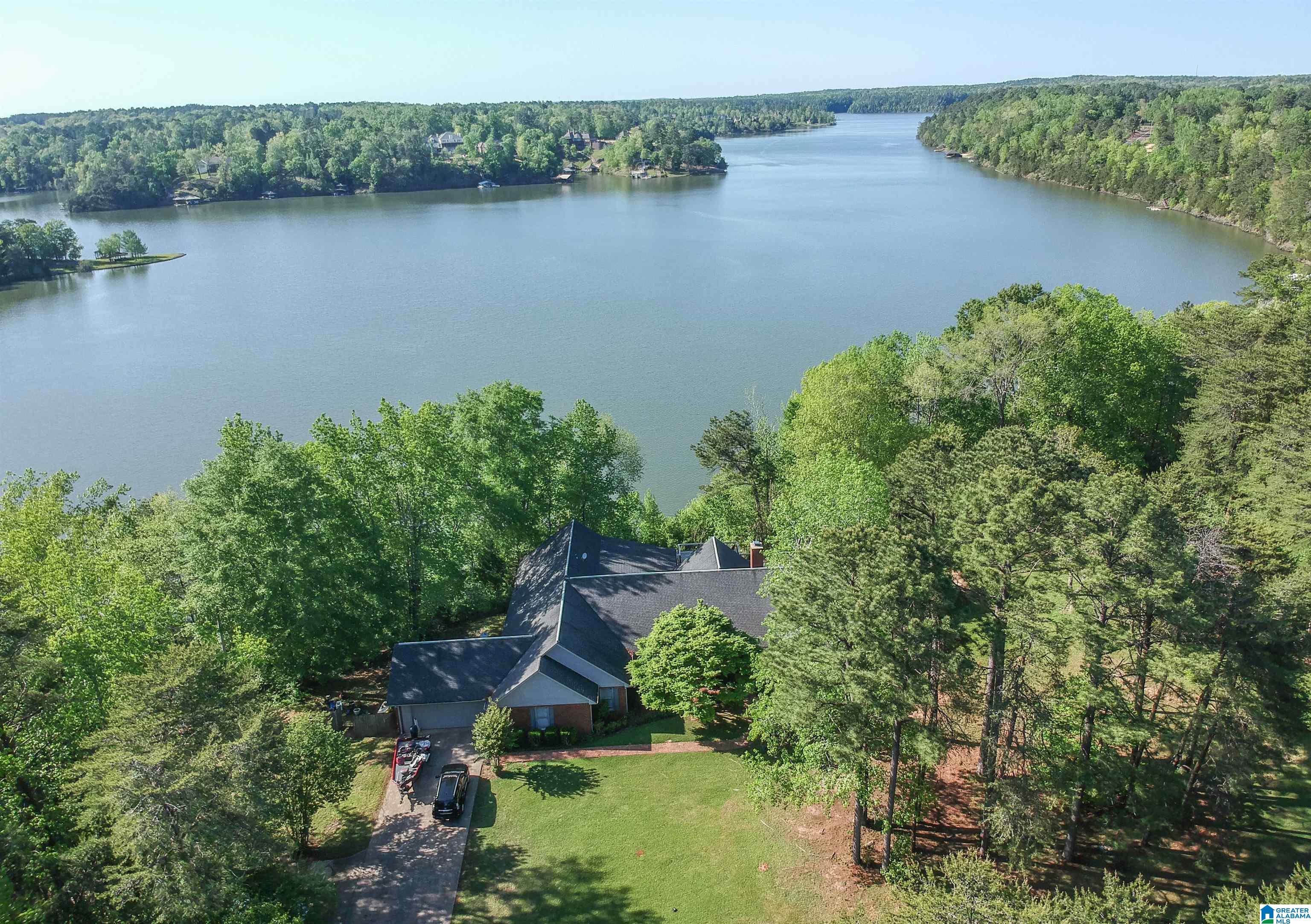 This spacious, split-floor plan home on Lake Tuscaloosa has +/- 463 ft of waterfrontage & views of the water from every angle. With a large deck spanning the back of the house & stairs for a short walk down to the dock, this home is made for lake living. Entertain in the formal living & dining rooms, or gather in the huge family room with new windows & a raised hearth fireplace from floor to ceiling. Enjoy the kitchen with a walk-in pantry, granite countertops, & eat-in island. Relax in the master bedroom with deck access & more beautiful views of the lake. This home has lots of built-in storage, the largest laundry room you'll ever see, & a den with a bonus bedroom. It sits on a beautifully landscaped lot of 1.87 acres on a dead-end street. Call Carrie today to schedule a tour.