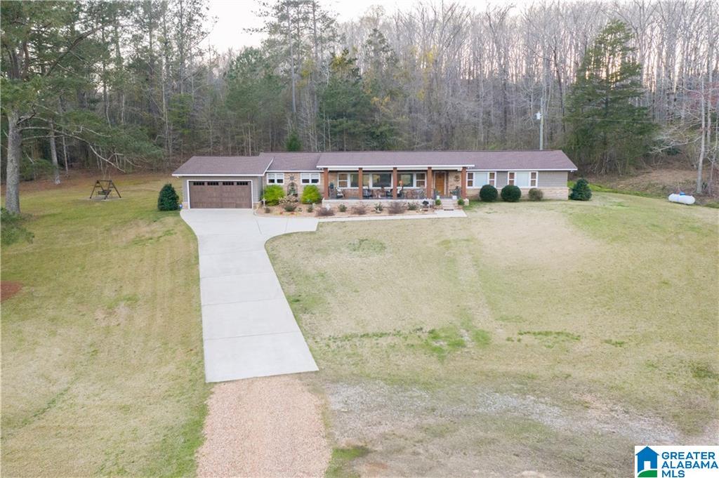 An incredible opportunity to own acreage and a custom built home located only minutes from all amenities. Behind a private gated entrance you will find a beautiful 3 bed, 2 bath home nestled atop a hill overlooking the private pond and 40 acres that make up this property. The land is made up of mature timber and is ideal for the hunting enthusiast. If fishing is your thing, the 5 acre pond is stocked with large mouth bass and bream. The 40X60 shop will provide plenty of room for your toys, including a camper hook up with septic. This home is the perfect place to relax and entertain as it offers an open-concept kitchen and living room space with an amazing back porch just off of the kitchen. Additional features include, upgraded floors, light fixtures and 2 soaker tubs, just to name a few.