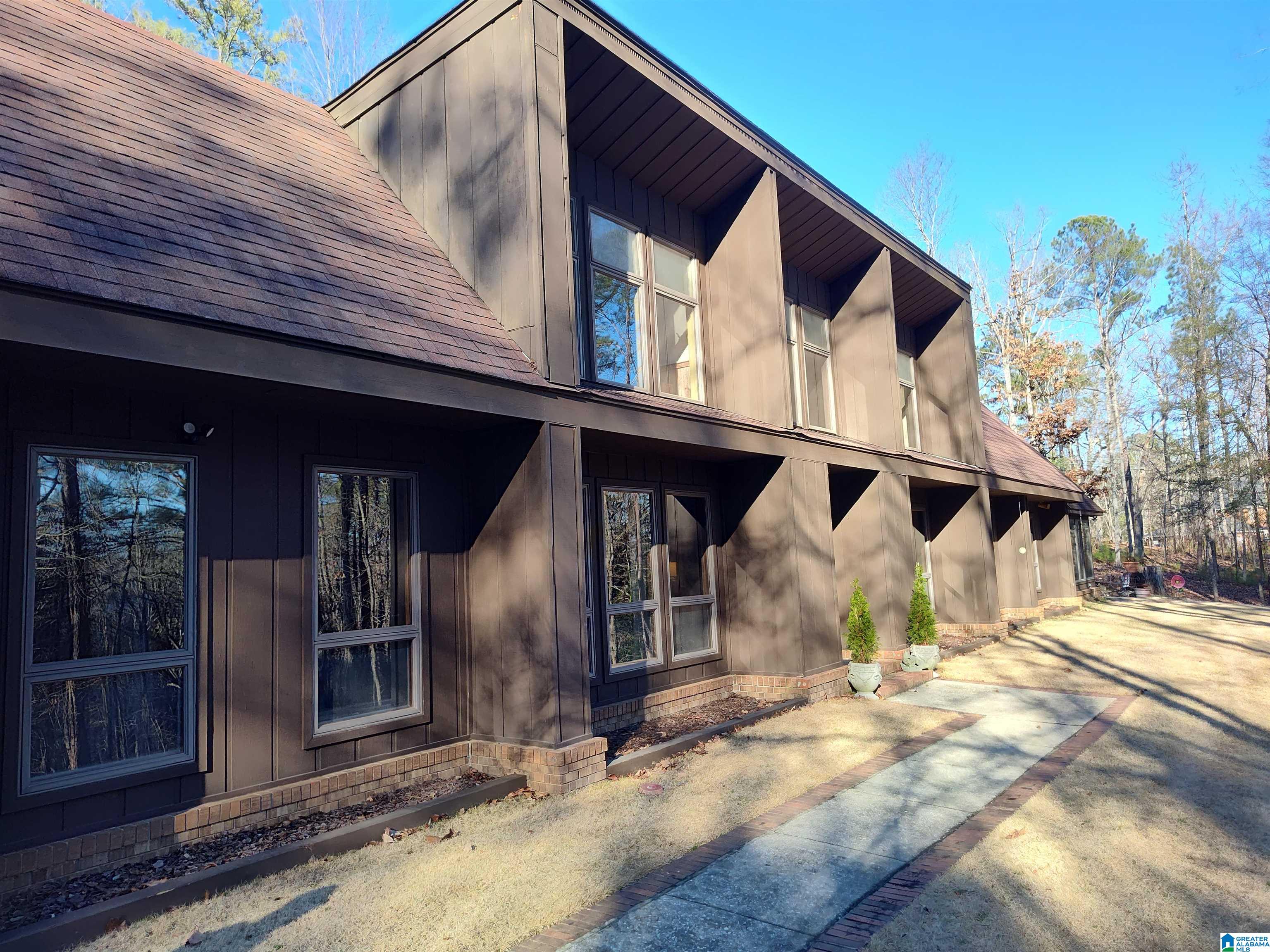 Great, one of a kind custom home in Sylacauga! This is a passive solar home,built against the mountain, with 3 bedroom and 2 full baths, plus an extra bedroom upstairs or office. Relax in the full glass sunroom, overlooking beautiful wood! Hardwood floors, a beautiful fireplace, granite countertops, 2 car garage are just some of the amenities of this beautiful home!