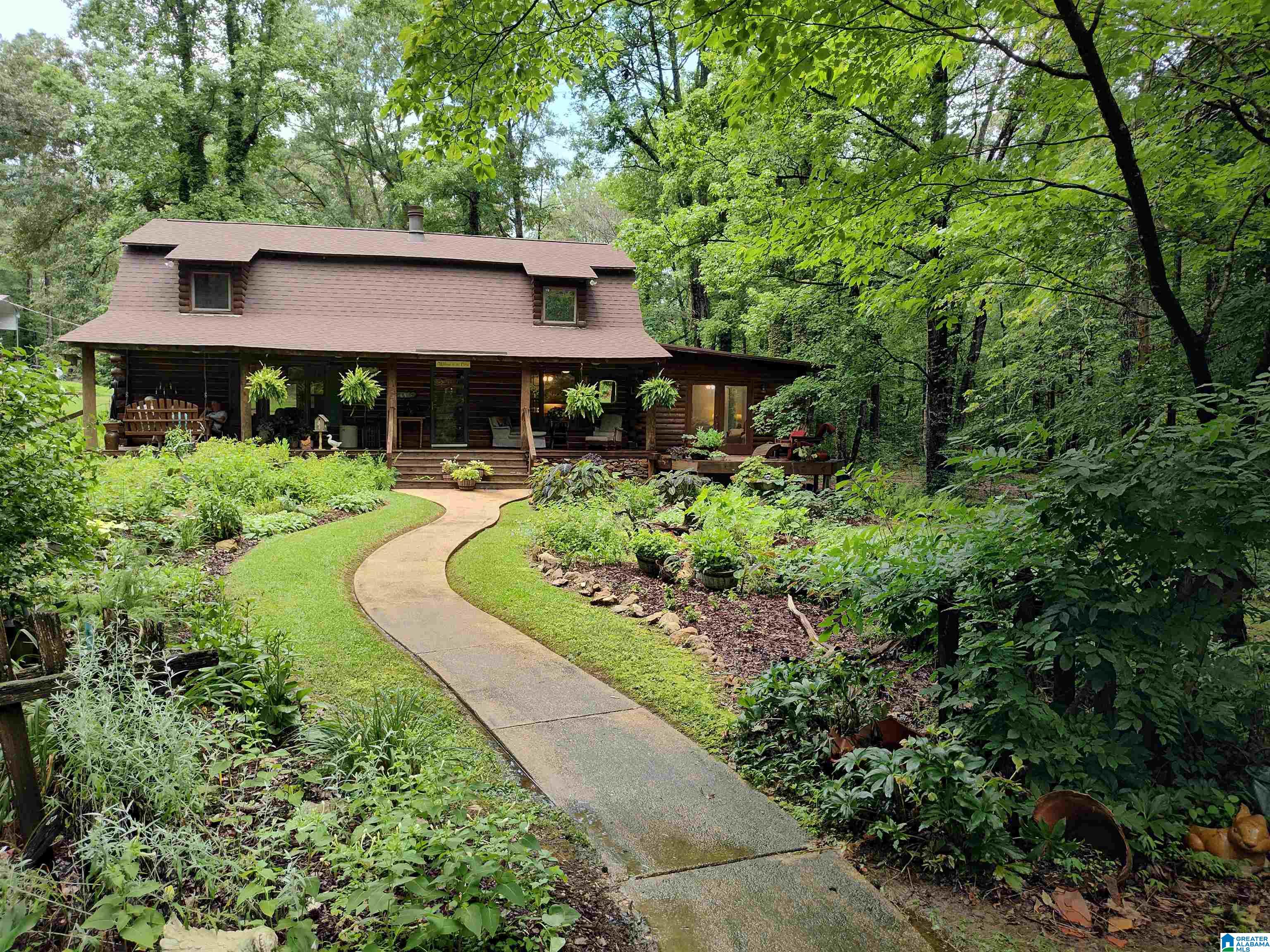 An exceptional property! Nestled among the hardwoods, this 4-bedroom, 3 1/2 bath log home is a must-see! Relax on the front porch, enjoying the scenery, or take in the beauty of the log and beam interior, with a rock fireplace: beautiful refinished pine floors, slate floors, and an eat-in kitchen with stainless appliances. Enjoy the first-floor master suite, featuring a sitting area and a private outside deck with French door access. Did I mention the huge,  log-sided shop? What a great place to store your equipment, etc. The shop has two extra-wide roll-up doors. Plus a finished office room, and a huge rv carport! This property truly has it all!