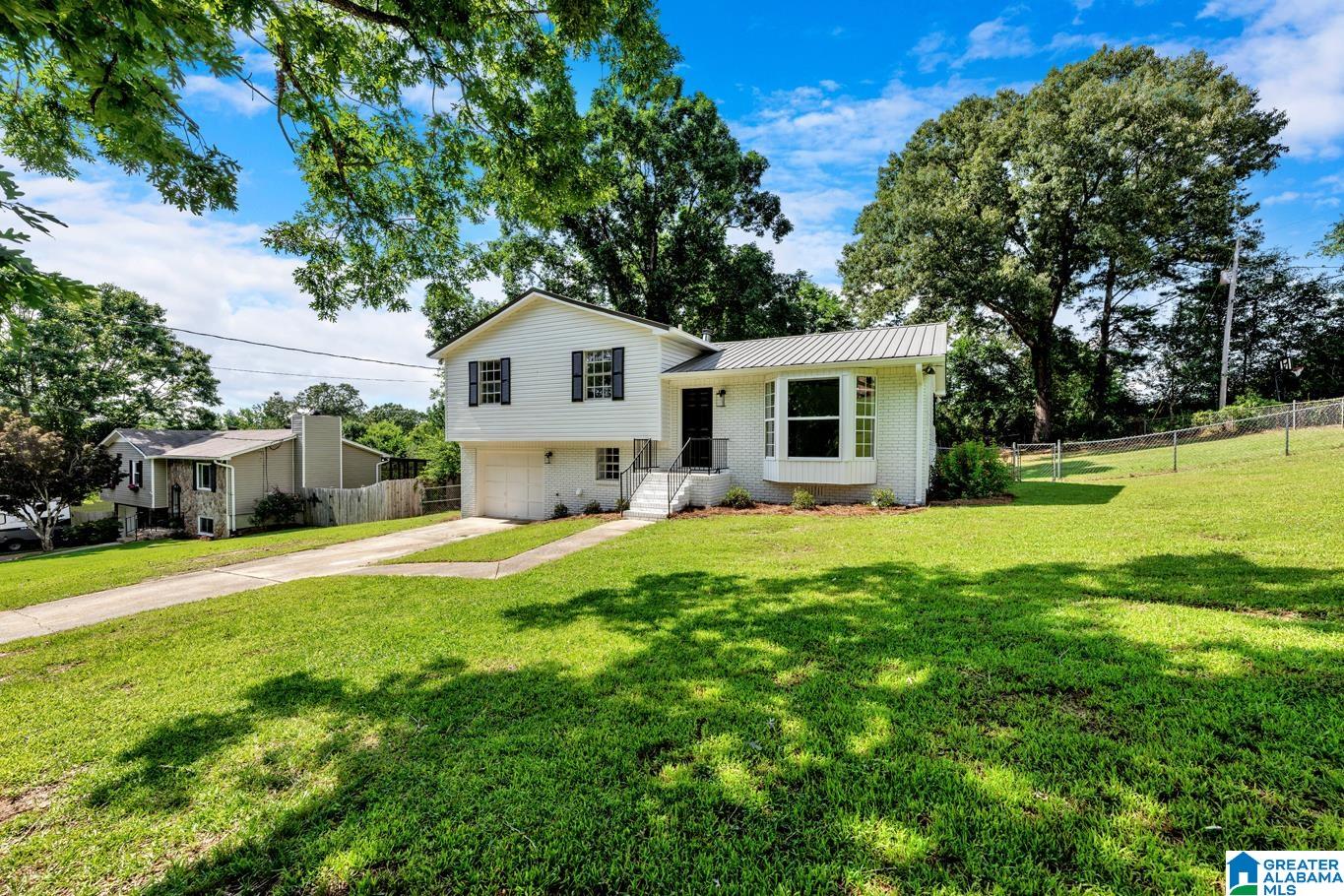 This BEAUTY is move-in ready! NEW flooring throughout, NEW kitchen cabinets, NEW countertops, NEW appliances, NEW bathrooms, NEW tile, NEW back deck, NEW interior and exterior paint. HUGE corner lot with large fenced area. Kitchen overlooks an amazing deck and yard. Incredible accent wall in kitchen. Basement den with a cute laundry room with barn doors. One car garage for vehicle or storage. This one amazing!
