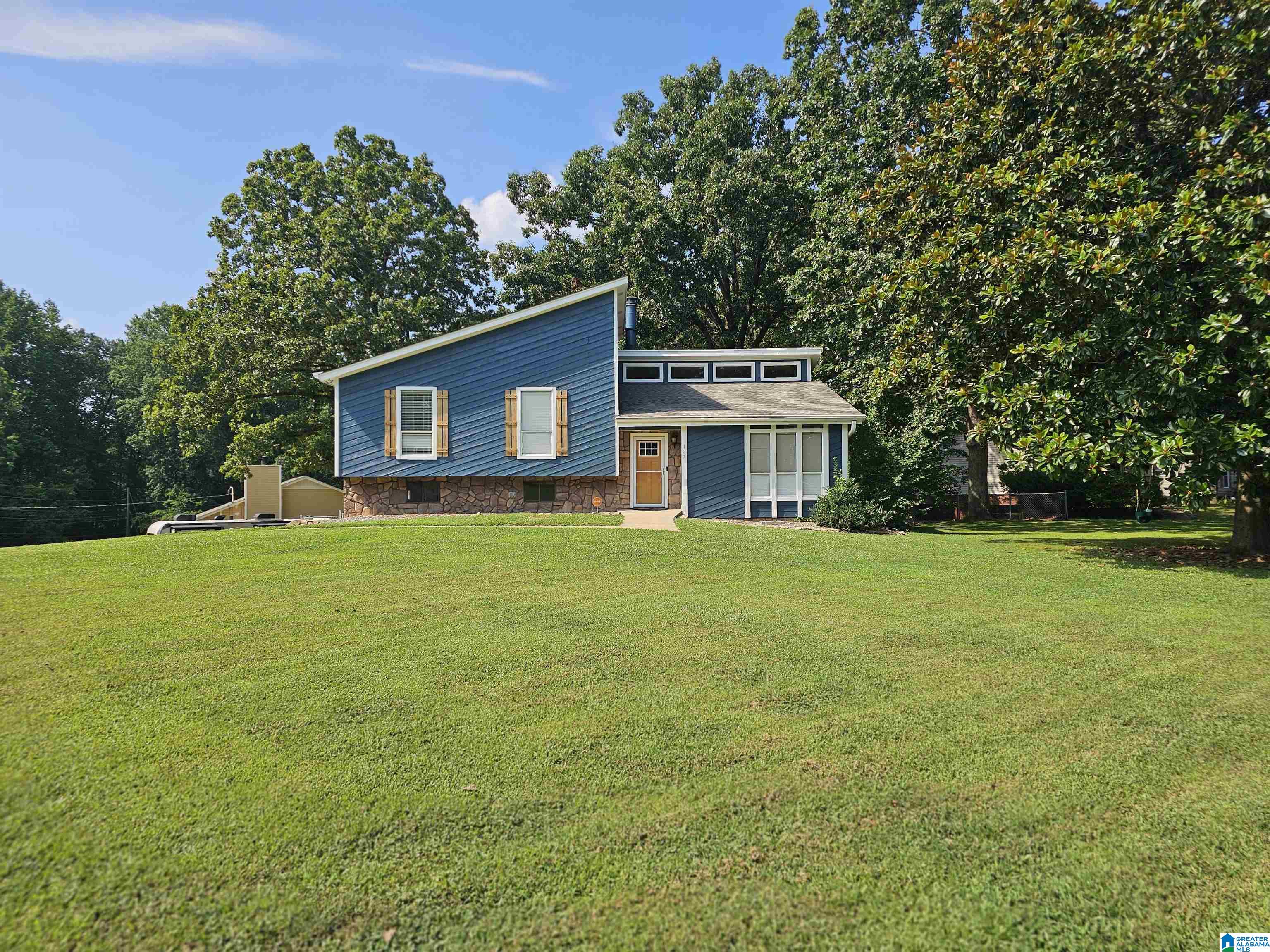 OPEN HOUSE Sunday 7-13-25 from 2-4pm!  Come see this wonderful home with so much living area.  The features include an amazing floor plan with a nice living area on its own level with wood plank vaulted ceilings, the kitchen is a home makers dream with stainless steel appliances, large double sink and tile flooring.  The sunroom is a peaceful retreat seeing nature all around through three walls of windows. The bedrooms and baths have plenty of room and storage.  Outside is a paradise which includes a fenced back yard and an amazing oversized deck for grilling and chilling. The front yard is level with a beautiful Magnolia tree. The 4th bedroom in basement has a nice woodburning fireplace and could double as a Man Cave or Media room.  This gem will not last long so schedule your appointment today!
