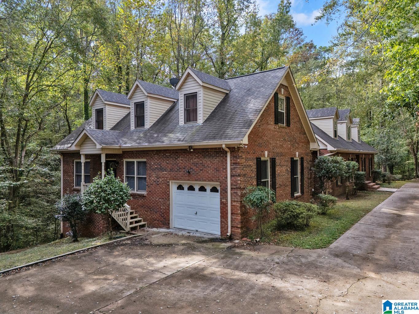 WOW! This one has it ALL! So much space, so unique and so private on 3.3 acres. In-law apartment on main level with private entry, 2nd kitchen, 2nd master bedroom, bedroom, full bath and one car garage with private driveway. The main house offers a huge kitchen with tons of cabinet and countertop space, updated appliances and breakfast area plus a breakfast bar. Formal dining room, formal living room, two story foyer and a beautiful fireplace in den. Master bedroom offers a walk-in closet, his and her vanities, garden tub and separate shower. Additional bedroom and full bathroom on main level. Upstairs has two big bedrooms and full bathroom with separate sinks. There are two large walk-in attic space that you can easily turn into additional bedrooms or living space. The biggest basement you've ever seen! Unfinished and the possibilities are endless. Two sets of stairs to basement, tons of storage and can park multiple cars and boats. So much parking with two driveways & circular drive!