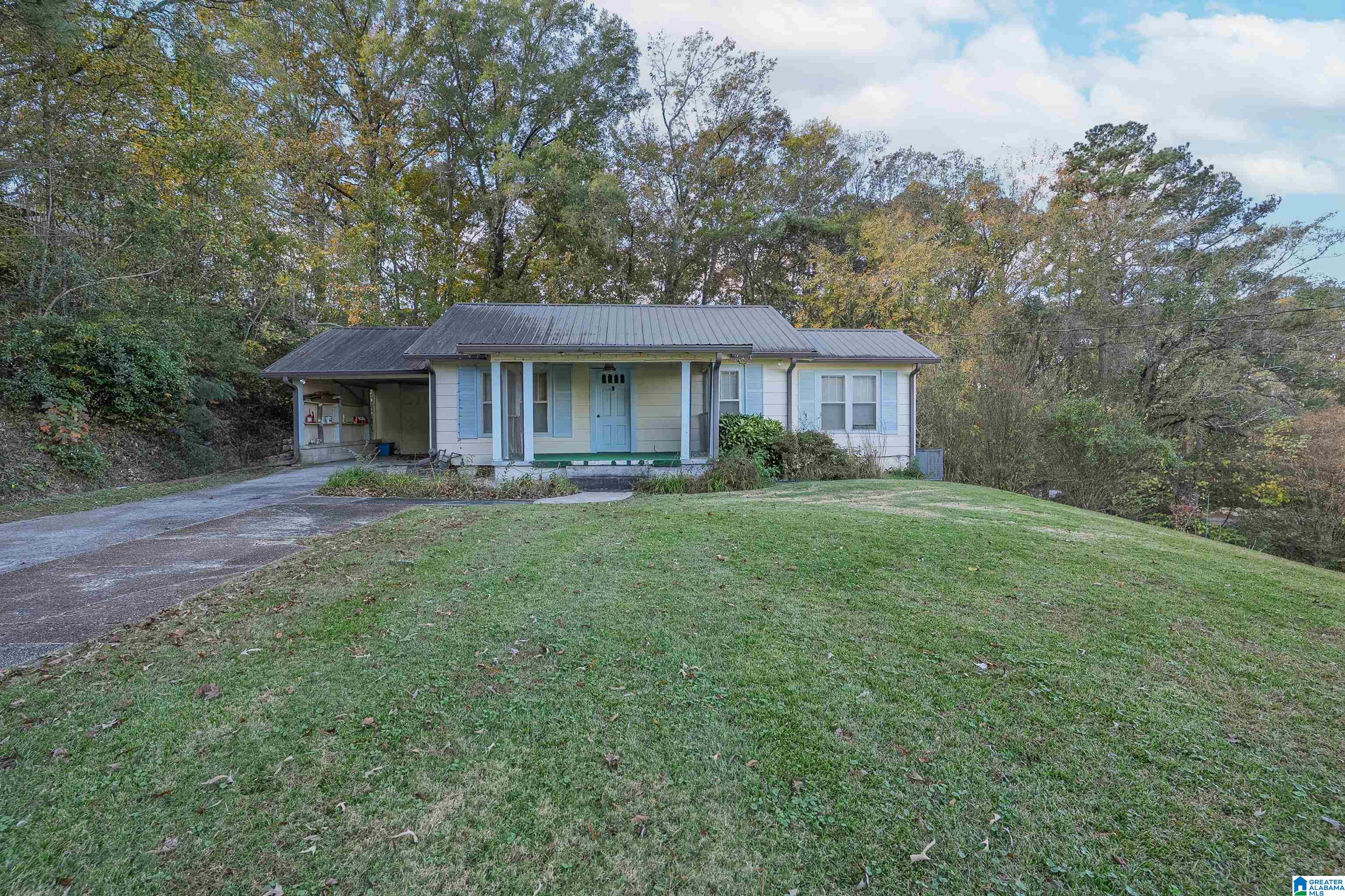 Vintage cottage in super convenient location!  Easy walking distance and just up the hill from all the fun at Trussville's Entertainment District. Even though this property is on a primary roadway, it's tucked in between a hill on one side and sits above the property on the other side so it just feels very private.  A huge plus is how level and flat the large yard is! Home is ready for a re-do and/or renovation so if you have your heart set on something that can be SO cute and already has a charming little front porch and welcoming curb appeal - you'll find endless possibilities here!