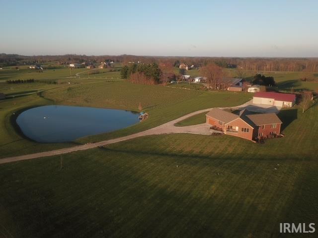 Incredible home on almost 6 acres with a pond in the Ferdinand area with a one bedroom guest quarters.  This home has tons of craftsmanship throughout house.  Custom built and only 7 years old.  Walk into this home designed to take in the beautiful views of the countryside from every angle with beautiful windows everywhere.  The floors are White Oak wood floors.  Open floor plan.  The kitchen has custom Oak cabinents with beautiful detail and a gorgeous island with granite countertops.  All appliances included.  Enjoy your countryside setting in your sunroom area with a book from your custom book shelf with pieces of wood from the Monastery.  Half bathroom is gorgeous with antique chest with sink.  The master is on the main floor and is very spacious and views as well.  The closet is huge and the master bathroom is wonderful with a double sink, large walk-in shower with two shower heads, and tile floors.  Furniture piece for storage is included in the sale.  The laundry is on the main floor and has a sink and folding area.  Head downstairs with a beautiful custom banister.  In the basement the floors are stained concrete.  The pool table is included as well as the safe.  The bar is beautiful and handcrafted with monastery wood as the countertop.  There are two large bedrooms, office, and full bathroom on the basement level.  The outside is incredible.  The back patio is covered and has a custom outdoor cooking area with sink.  The fire pit is set in an area for great views of countryside and lake.  The lake is very large with a dock for your summer enjoyment.  The detached workshop is built top notch.  Inside you will find a dust hose system, electric heater, and a half bathroom.  The floors have plumbing setup if you want to heat floors by an outdoor fireplace that needs to be added.  Attached to the workshop is a 650 sq ft apartment for guests or mother in law suite.  It has a family, dining, kitchen, bedroom, and full bathroom.  Extra storage can be found in the metal building behind the shop.  Geothermal heat and all electric house.