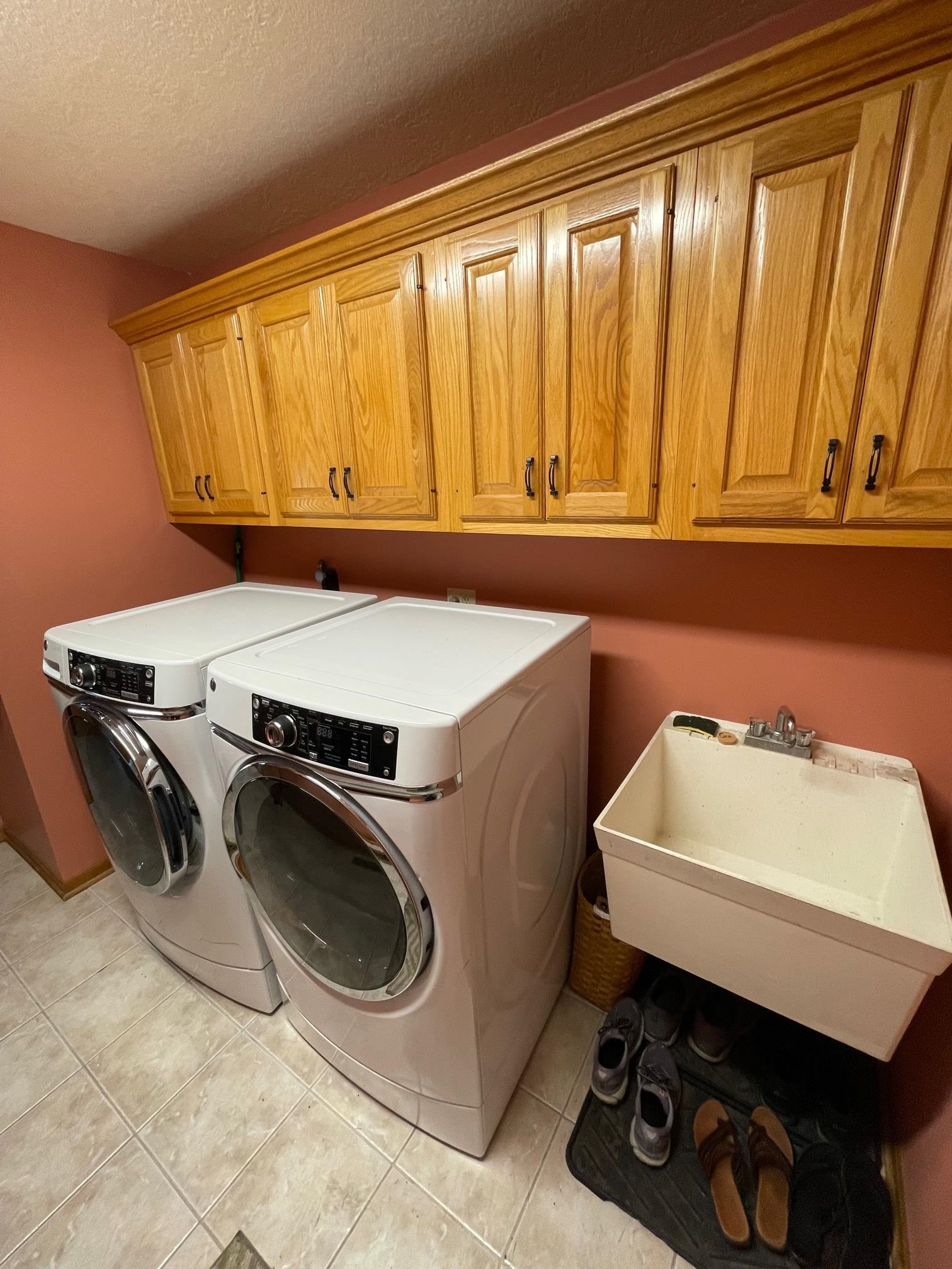 Huge main floor Laundry Room with sink and cabinets!