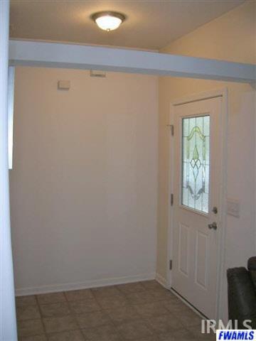 Foyer entry with ceramic tile opening to great room.