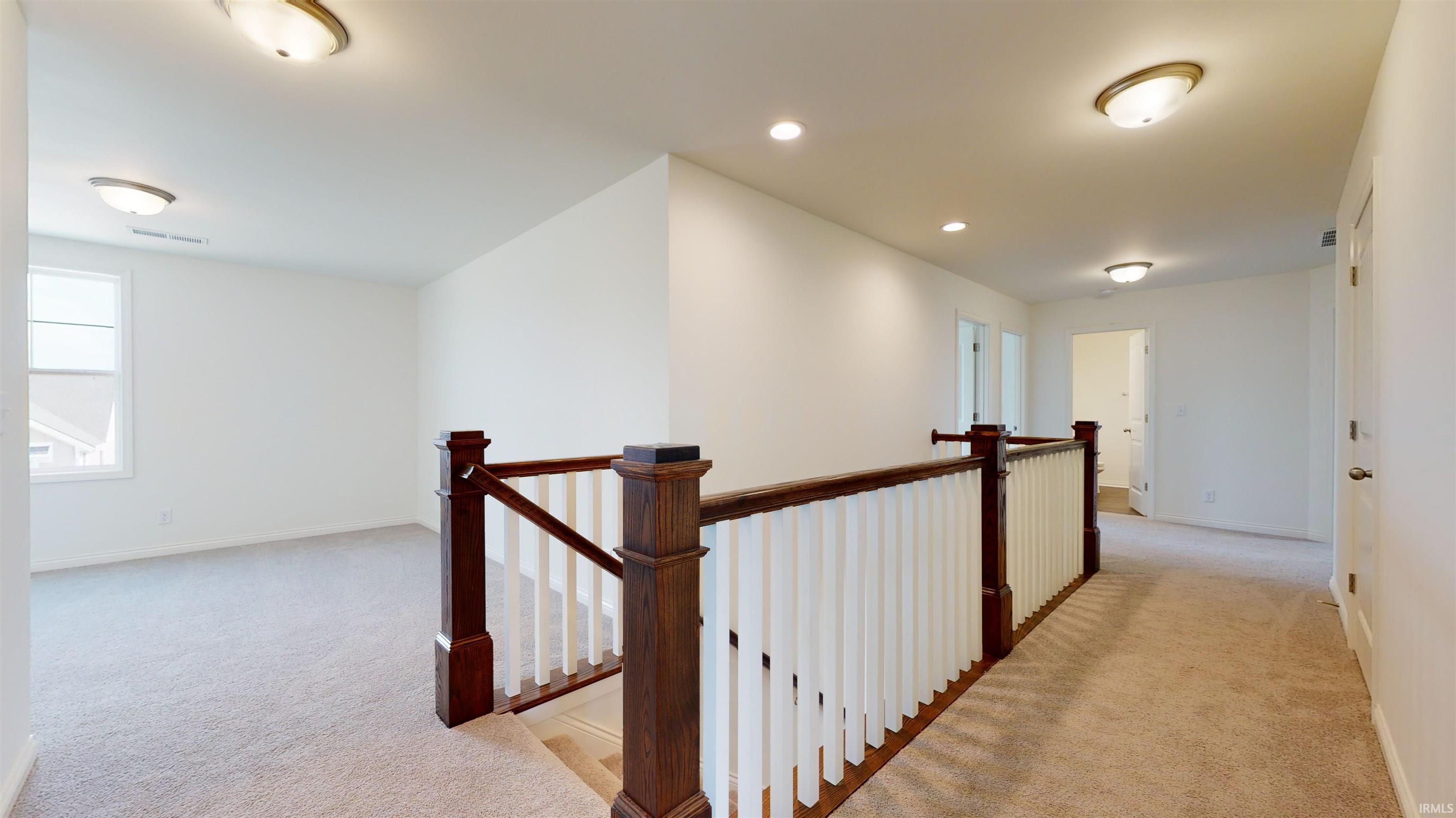 Decorative stained newel posts and painted balusters