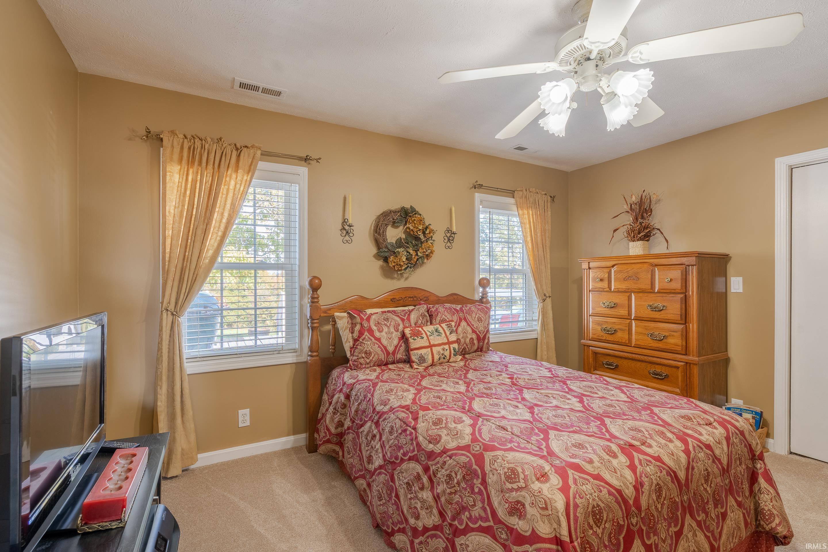 CEILING FAN, CARPETING AND A LARGE 6 FOOT CLOSET ARE JUST SOME OF THIS BEDROOMS GREAT FEATURES.