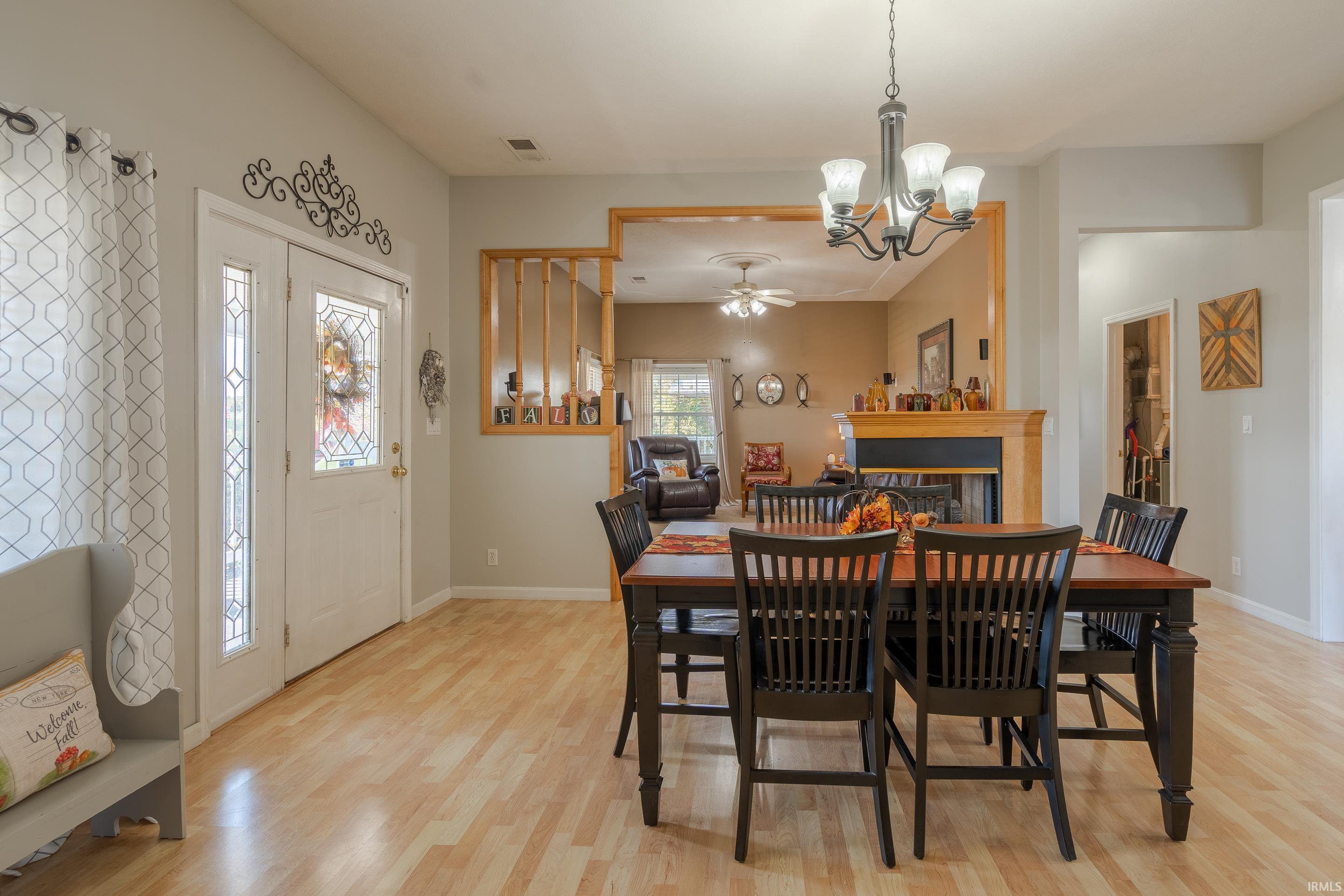 THE FRONT DOOR OPENS INTO A LARGE DINING ROOM WITH WOOD LAMINATE FLOORING.