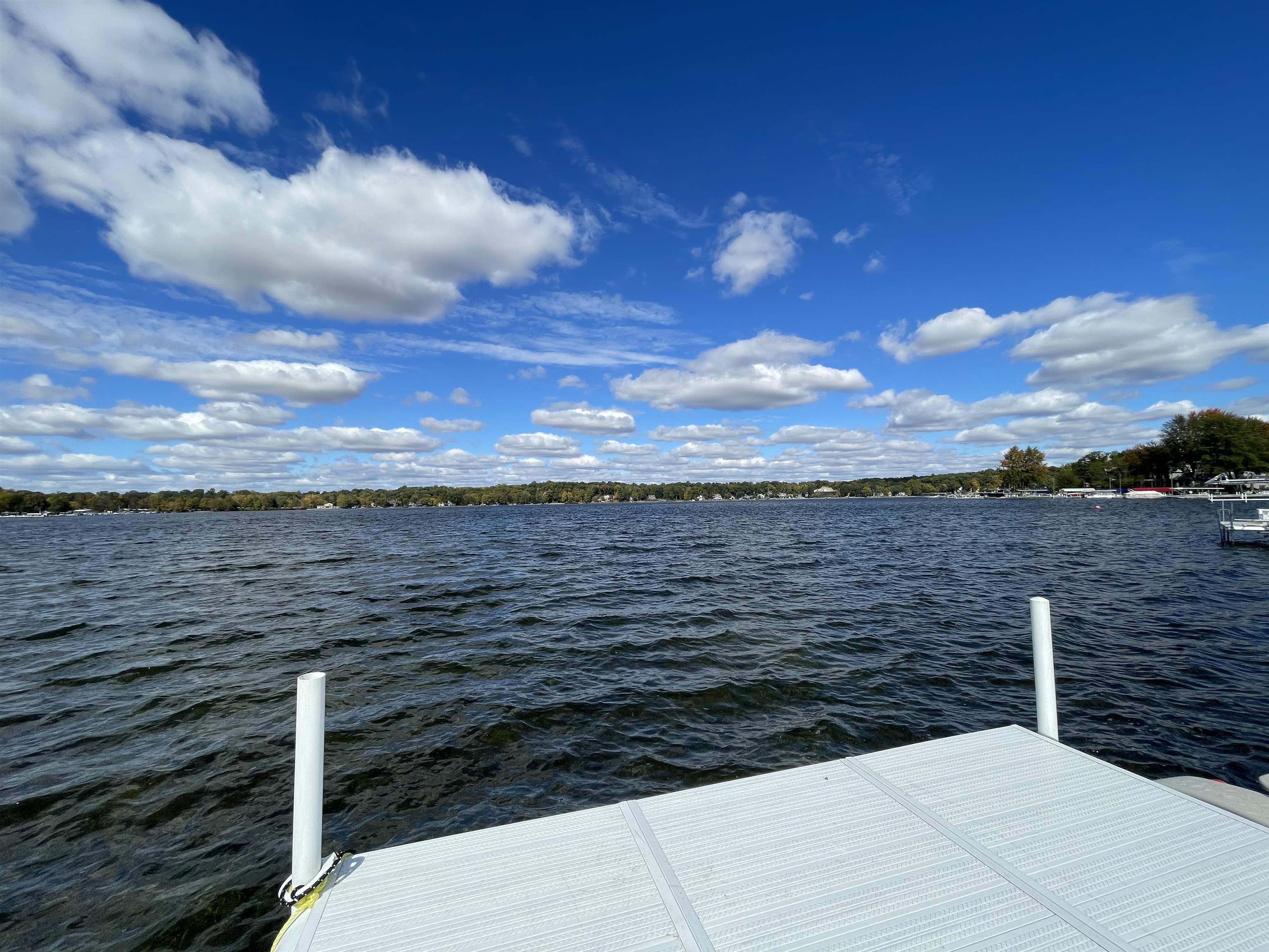 Welcome to this recently renovated lakefront property on Lake Tippecanoe.  Some renovations are still in process, however the home has so much to offer we could not wait to share it with you! 90 ft of lakefront with sunset views from this home.  Just under 5000 square foot of living space and the availability to finish even more space.  The floorplan has been opened up as soon as you walk in the front door with some walls being removed- the view from the front step draws you inside the home immediately.  A wall of windows greats you and tempts you with the fabulous lake views to stay a while.  Inside you will find an all new kitchen with custom cabinetry, commercial grade Forne Appliances in the Refrigerator, Freezer and 36 inch gas range/oven.  There are 3 bedrooms on the main level including the Primary Suite which has a brand new bathroom that is being finished up right now providing an oversized walk in shower, tile flooring, new double vanity and soaking tub perfect for this oasis.  Large walk in closet completes the space.  There is a double sided fireplace in the master as well as access to the deck, easy access to the new hot tub on the deck and lets not forget to mention the lake views.  On the opposite wing of the home, you will find 2 additional bedrooms and 2 additional full bathrooms as well as a sunroom w Conceirge Center/Coffee Station and access to front deck/lakeside yard.  Laundry room and separate entrance are also found on this level- providing the opportunity to rent out upper level for vacationers if needed.  Upstairs you will find an expansive family room- vaulted ceilings and a wall of windows to make the most of the lake views.  Balcony/porch overlooking the yard and lake as well as 2 more additonal bedrooms and full bath- and there is even a loft with fireplace that could be an office, additional bedroom or what ever space would be needed.  Lots of options in this wonderful home on the shores of Lake Tippecanoe- and all sports lake.  Sewers will be coming thru in the future.