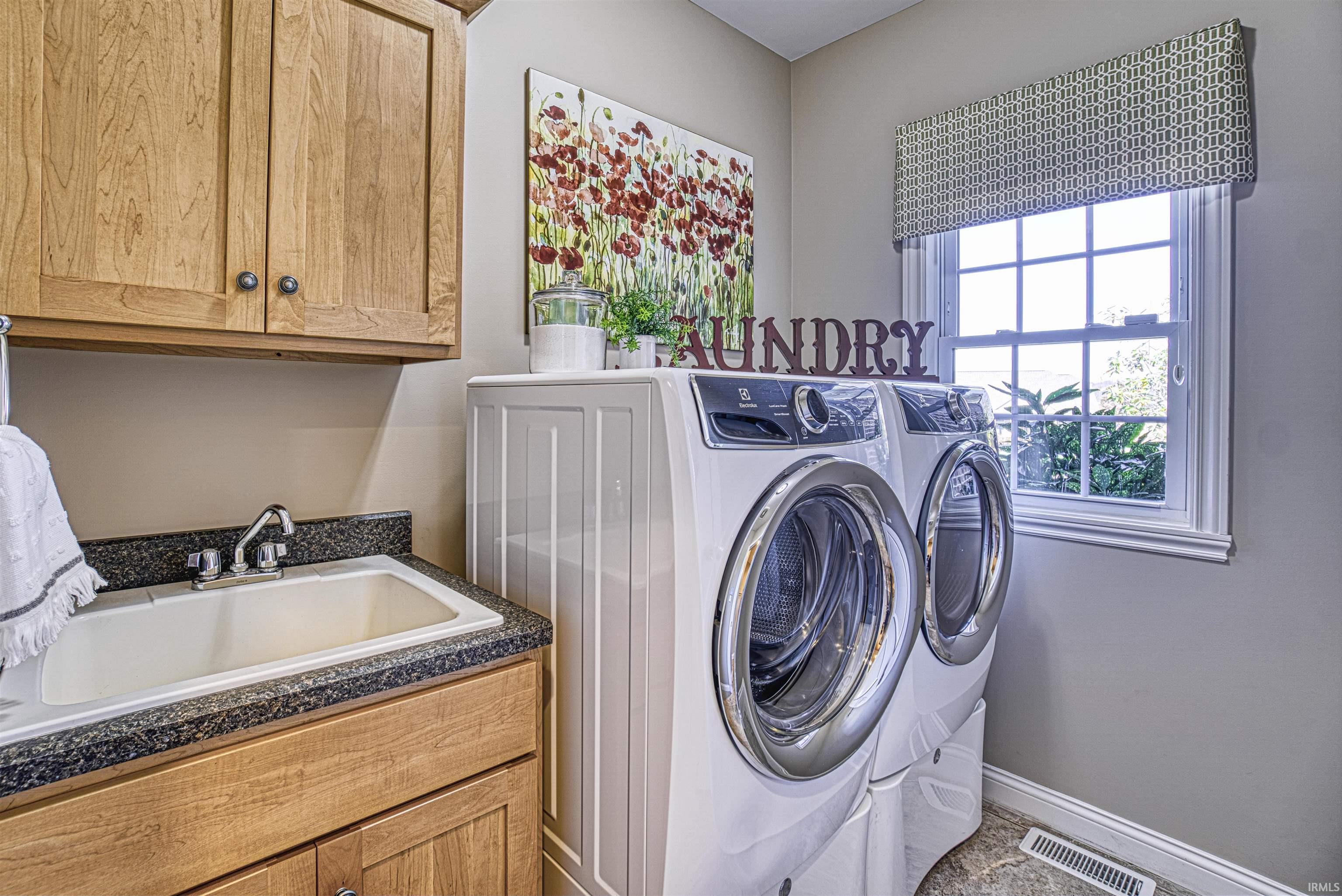 Laundry with washer and dryer included is located off the 3 car garage