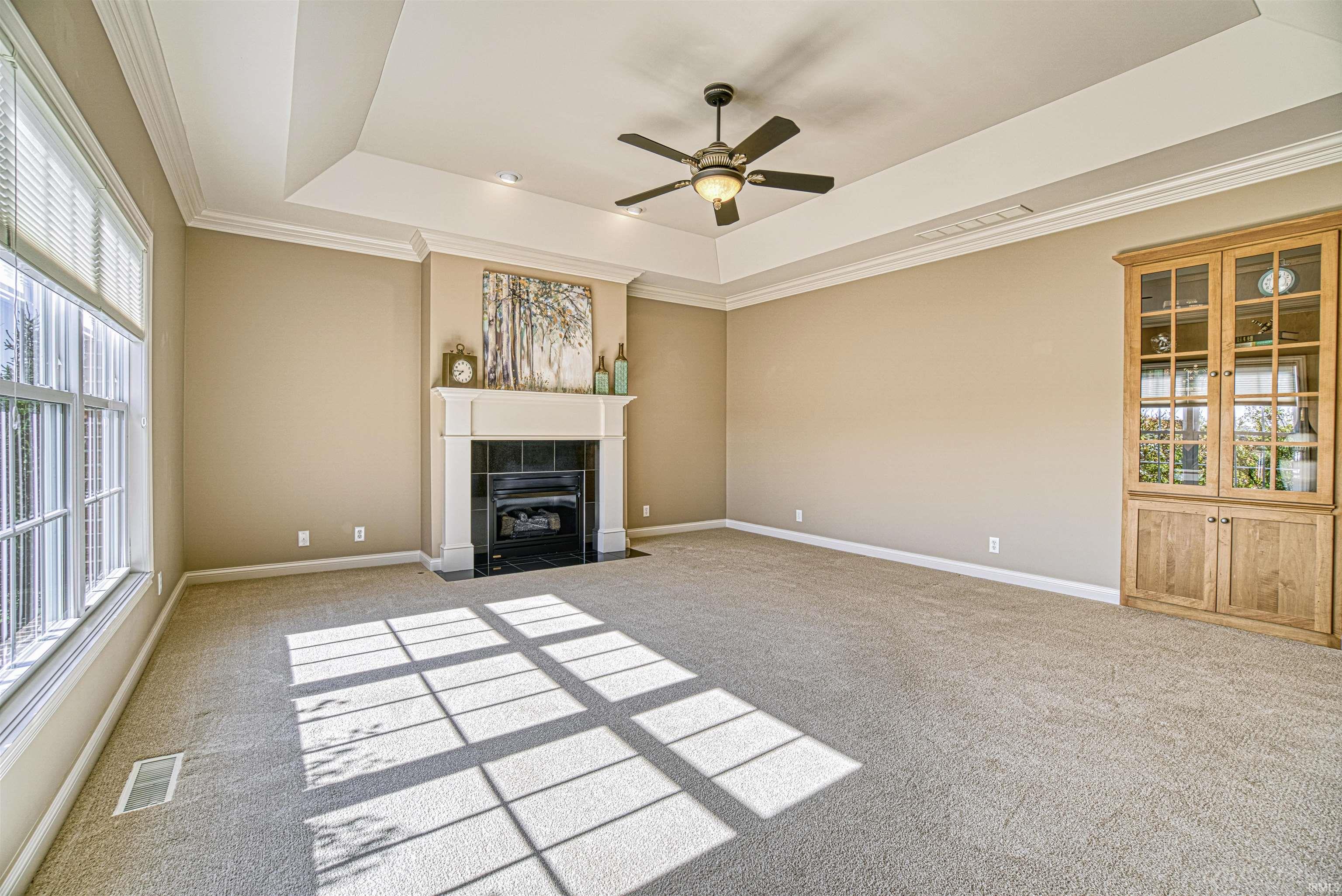 Additional features include tray ceiling and custom built-in