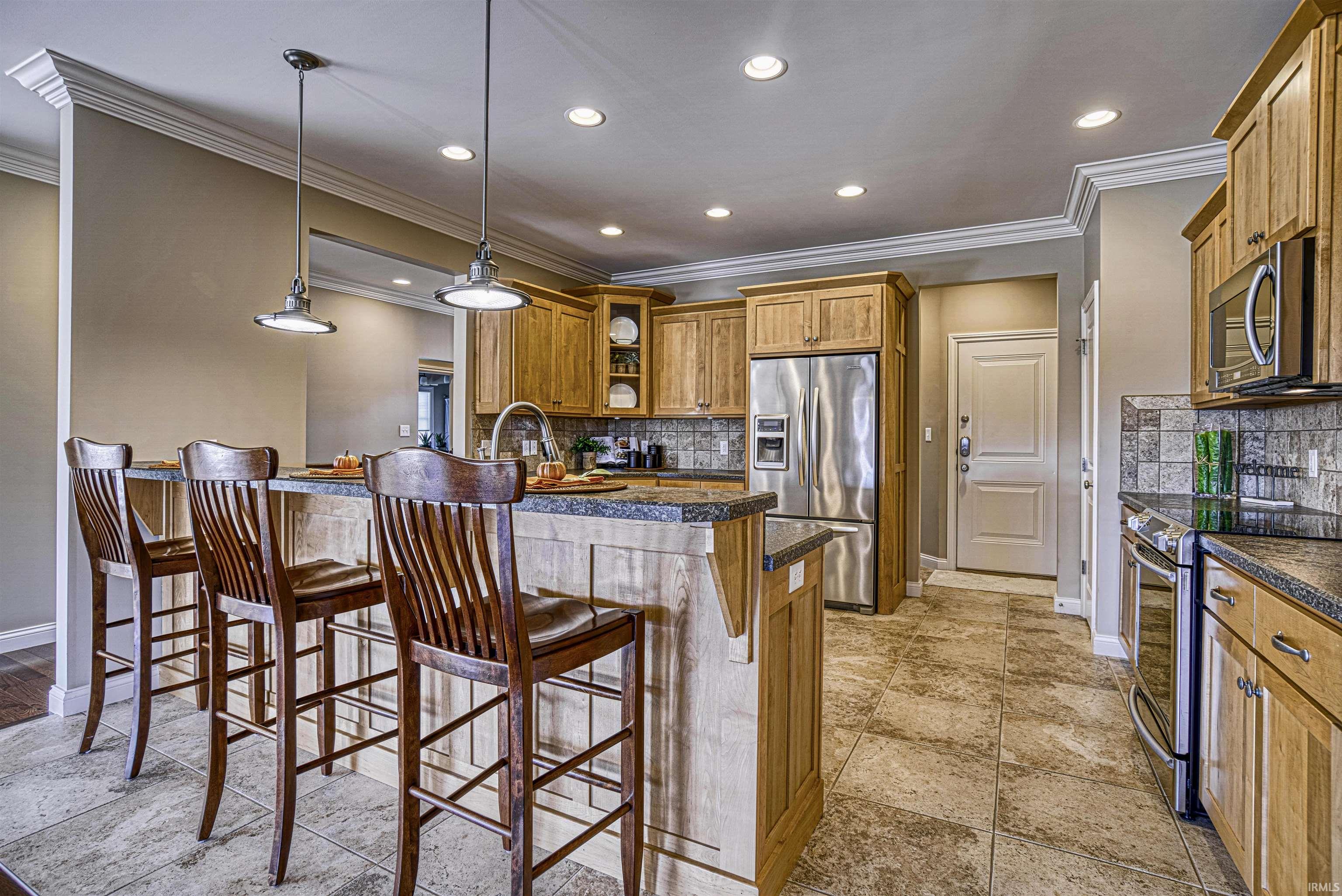 The kitchen with raised breakfast bar and pendant lighting will delight any cook with...