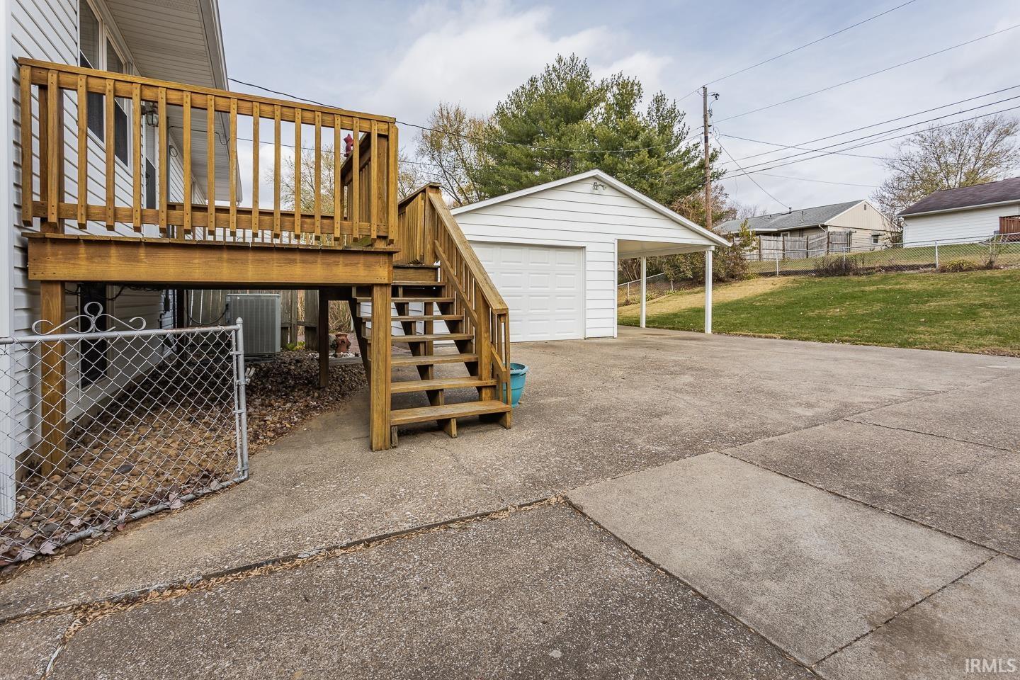 he Deck off the back of the home is a pleasant place to enjoy the quiet, fully fenced backyard, and there is a little private tucked-away patio area between the garage and home.