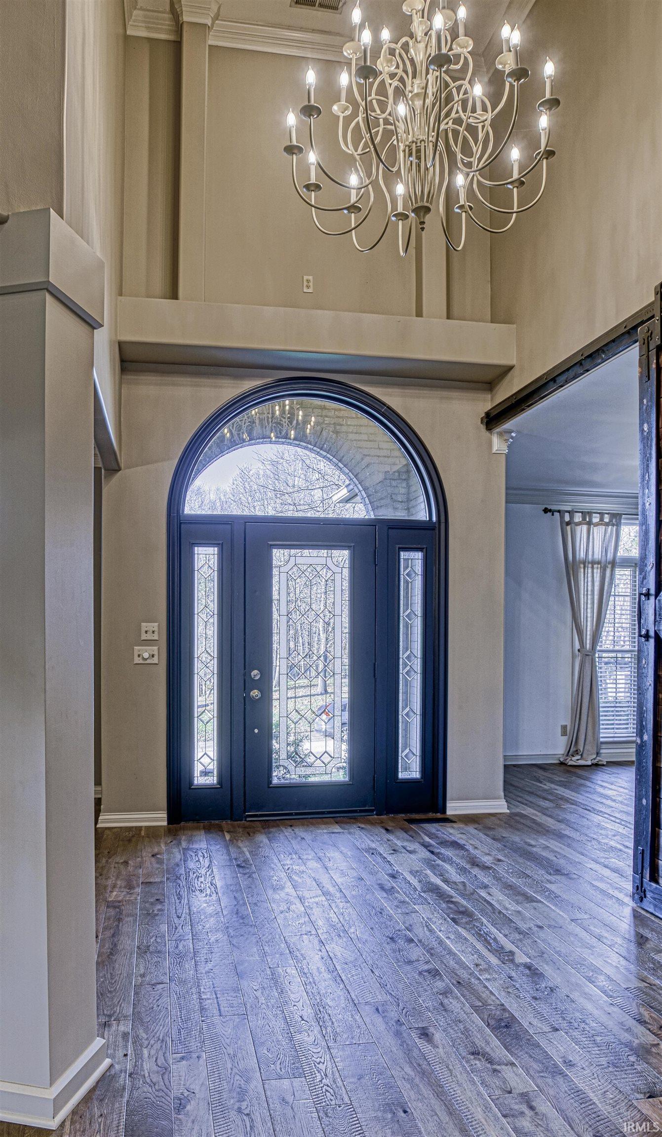 The gorgeous two story foyer is the perfect greeting for your guests and features a...