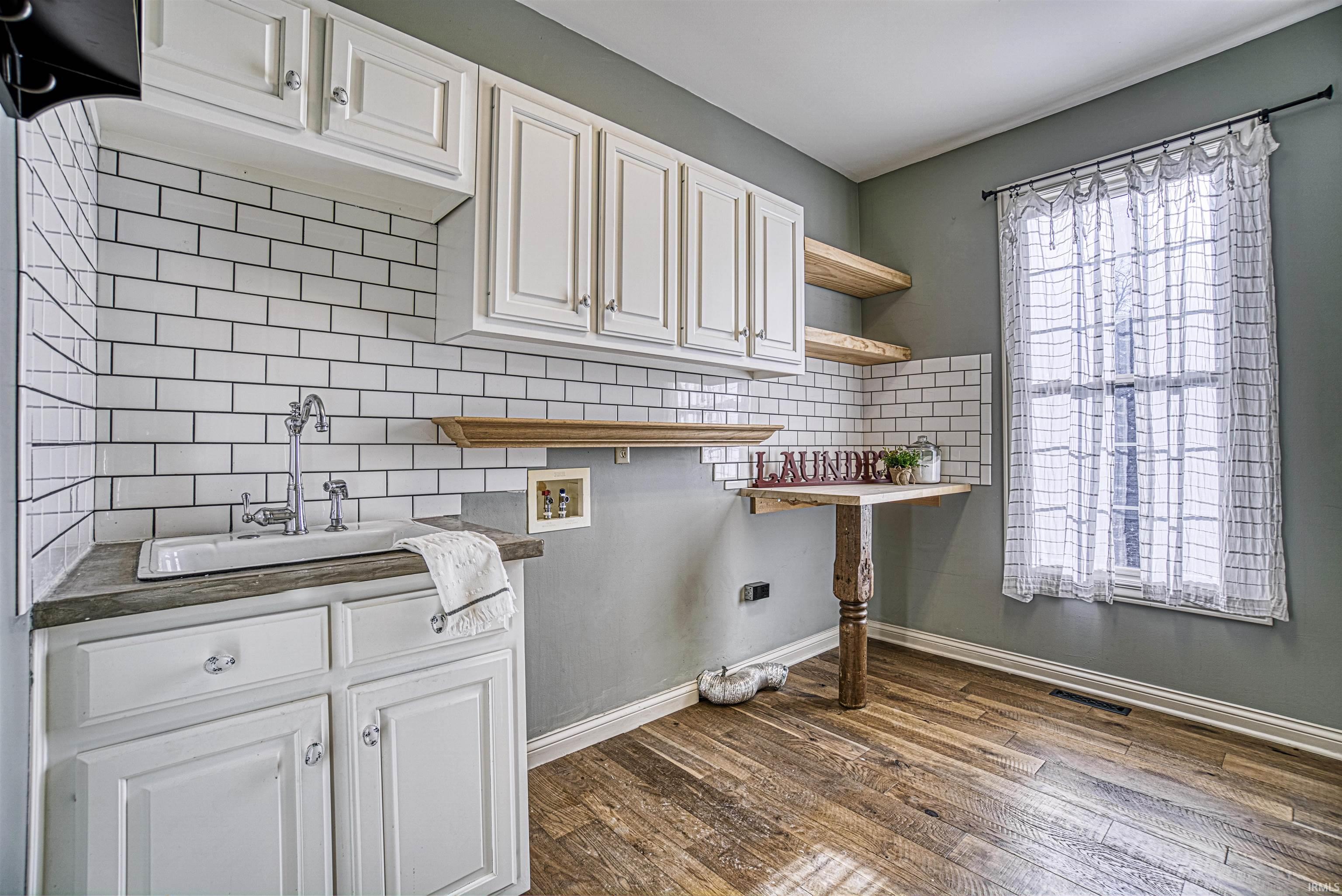 The large laundry offers sink and cabinetry