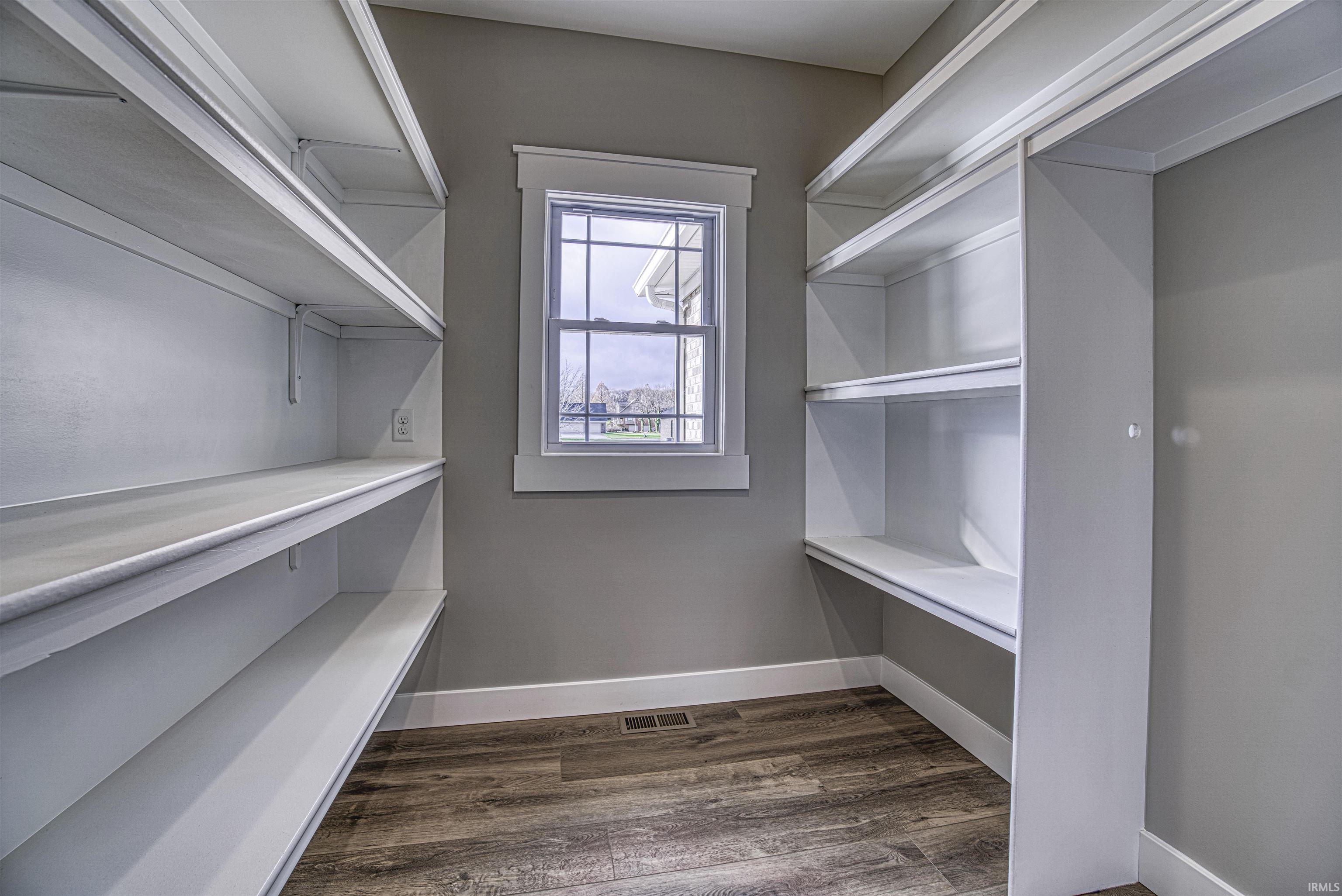 13x7 walk-in pantry with custom shelving and space for refrigerator