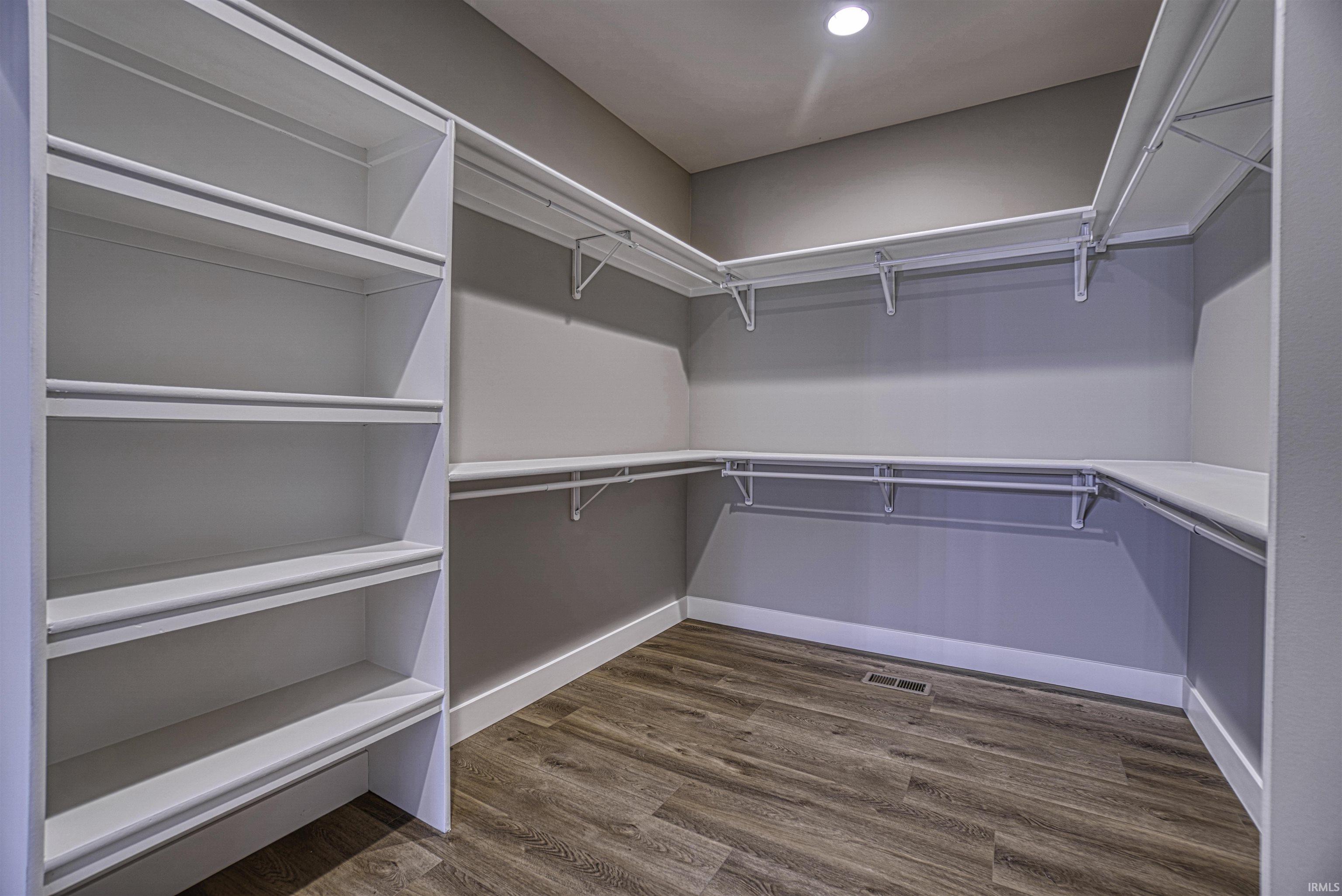 Walk-in closet with custom built-ins and access to the...