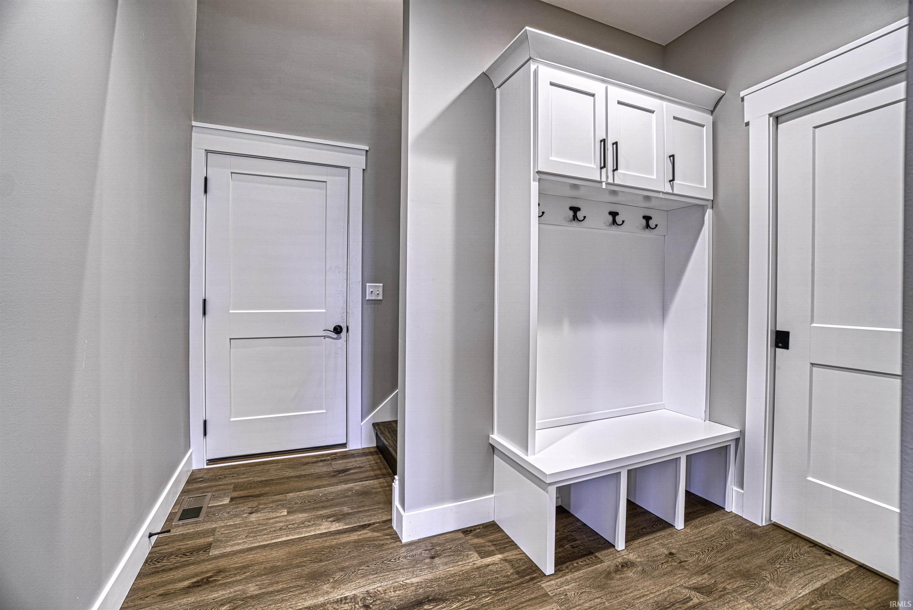 Mudroom with cubbies located off the garage entry with access to the...