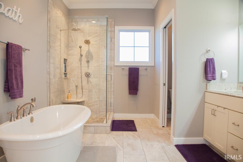 The bathroom is a true delight with free standing tub, tiled walk-in shower w/glass walls...