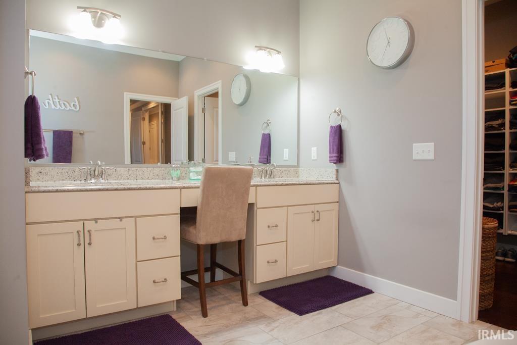 The spacious dual sink vanity of the Owners Suite....a large walk-in closet is located just off the bath....