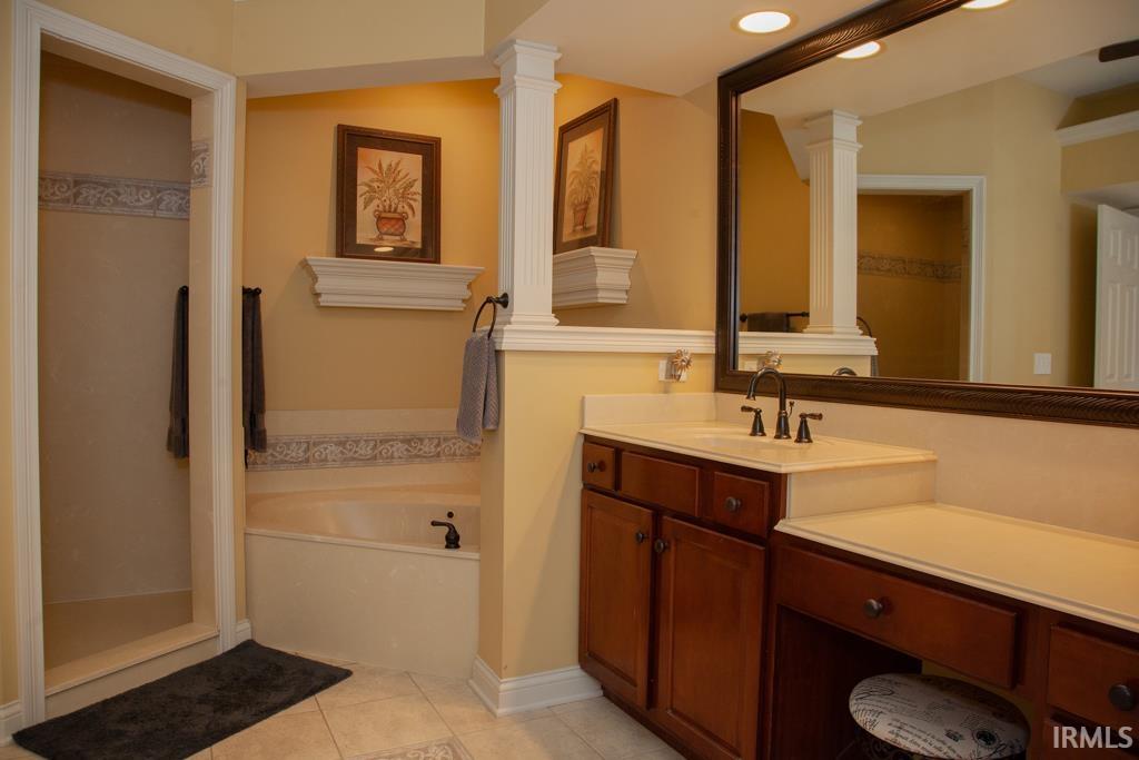 Private master bath with ceramic tile shower and separate tub