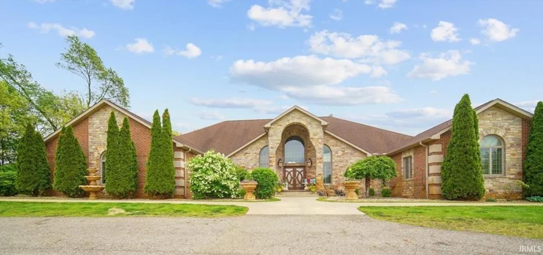 This beautiful 9,000sq/ft home sits on almost 33 acres. Enjoy nature as your drive back the 1/4 mile paved 2 lane driveway. This 5 bedroom 4 1/2 bath homes offers plenty of areas to entertain. The grand living room with exposed beams overlooks wet bar and pool with floor to ceiling windows. The gourmet kitchen with custom cabinets and walk-in pantry offers plenty of storage. The breakfast bar that seats 10, dining area, and family room make for a wonderful place to gather. There's an office on the main floor along with Master suite with private deck, spacious bathroom, walk in closet with washer & dryer. 2 additional bedrooms with one having it's own en suite. You can take the elevator or beautiful staircase to the ground level.  The ground floor offers 2 bedrooms, large walk in closets with Jack & Jill bathroom.  Game room, gym, movie theater, wet bar area also on ground level. Step outside to your own sanctuary.  The in-ground salt water pool with automatic pool cover, pool house, outdoor kitchen, and firepit.  This property offers a 2,000sqft guest house with 3 bedrooms 1 bath with attached 5,000sqft pole barn. House generator, 1 acre pond stocked with bass and blue gill allows you to enjoy nature at its finest.