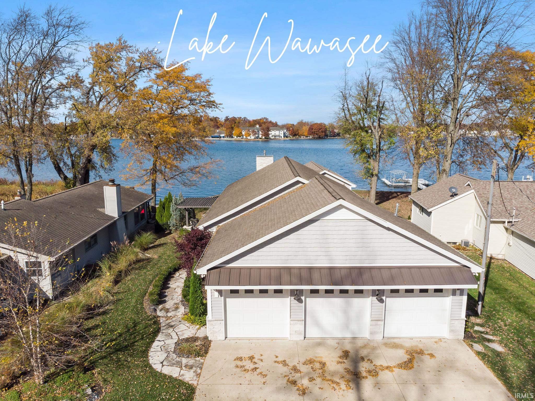 Just show up with your bathing suits! This 4688 total sq ft, newly renovated move-in ready home with has it all--except you! If you're in the market for a lake-level home that will create long-lasting memories for your family and friends, your search might be over w/this amazing find on fabulous Lake Wawasee! Imagine yourself relaxing on your new Craftsman Style front porch w/ panoramic views or sitting on your spacious waterfront stamped concrete patio, under your awesome pergola that is complete w/ gas grill, granite counter w/ stools, built-in firepit & outdoor TV. The main house has an inside & outside SONOS stereo system to enjoy w/ excellent sound. Landscaping is professionally designed. The large 125’ frontage provides plenty of picturesque views. Inside, the newly updated home features 2,488 sq. ft. of living space in main home w/4 bedrooms, 2 primary baths w/ a total of 3 full baths, engineered hardwood floors, custom blinds & draperies, Dacor Professional Gourmet Kitchen appliances, pot filler, large pantry for the family Chef, Quartz counters & professionally furnished w/ gorgeous furniture & decor (most items stay w/houses). The guest quarters provide 2200 sq. ft. of addt’l living including newly furnished efficiency apartment, decorated professionally w/1 bedroom, 1 loft area w/2 full beds, leather sectional, 2 full baths, & rec room w/new sleeper sofa, new additional couch & Custom Bar w/stools. The Rec Room comes w/ Pool Table, Foosball Table & Dart Game, built-in industrial gun safe, & built-in industrial wall unit. Huge fenced-in yard in back house for kids & pets that backs up to wonderful forest preserves that gives you access to the trail--located across the road behind backhouse. The generous .78-acre lot w/plenty of parking & 3-car attached garage in front house & 2-car garage in backhouse. Best yet, is the homes come partially furnished w/new furniture & some décor.  Two dock configurations w/Dock Boxes, Dock Bench & Flower Boxes for Docks.  Too many extras to mention! With picturesque views, spacious indoor & outdoor entertaining areas, & luxurious fixtures, this property truly is one of a kind! This opportunity won’t last! See Video Tour!