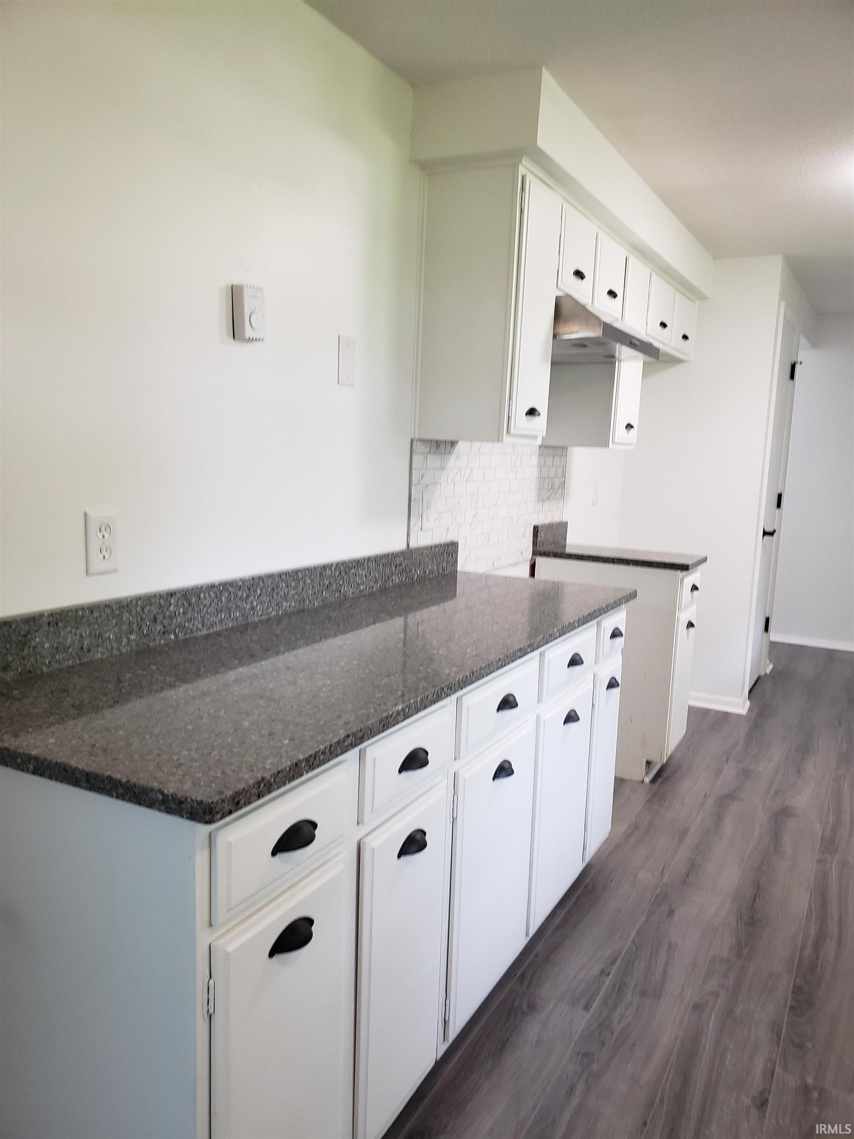 Large expanse of new quartz counter tops, ample storage.  Design opportunity for buyer to open kitchen to living room and provide bar seating at their expense to create an open plan.