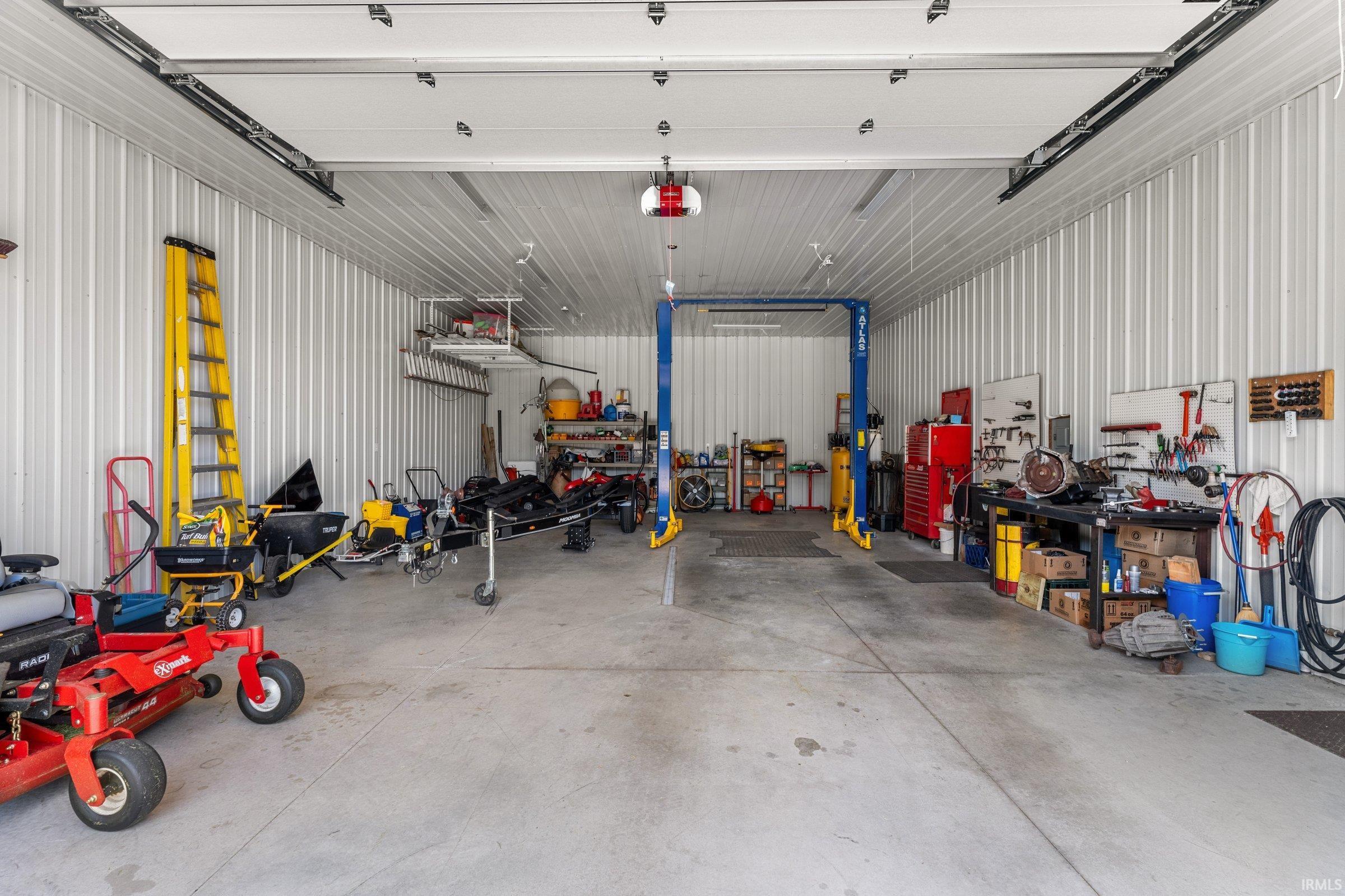 This custom built garage is complete with electricity, water, and heat. There is even a lift. The dimensions are: 28'x40'x12'.