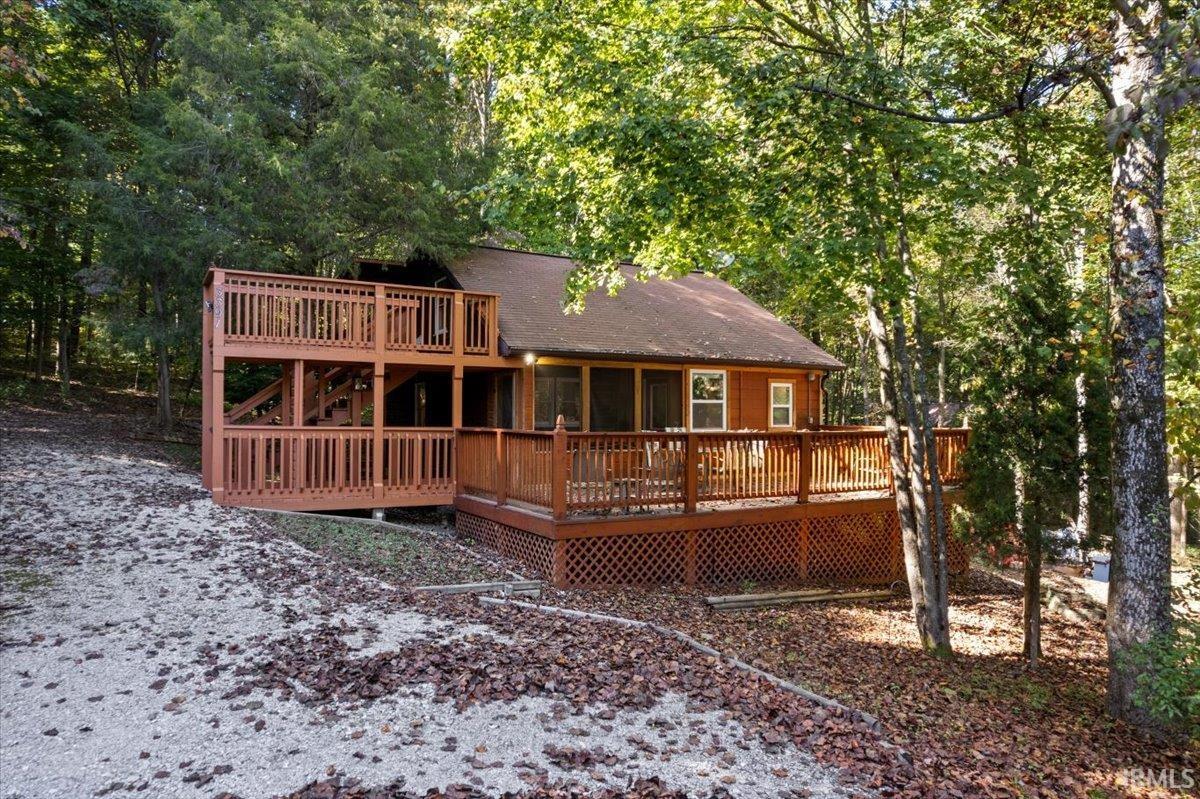 This charming cabin is nestled on 1 acre in the serene forest of Patoka Lake, offering an ideal private retreat or vacation rental. With 2 cozy bedrooms and 2 full baths, it can comfortably accommodate up to six guests. The cabin is fully furnished and turn-key, so you can start enjoying your stay right away. There are several areas to enjoy, including a spacious front deck, an upper deck, and a fire pit area. You will be in close proximity to various attractions, including Patoka Lake, French Lick, and the Patoka Lake Winery.