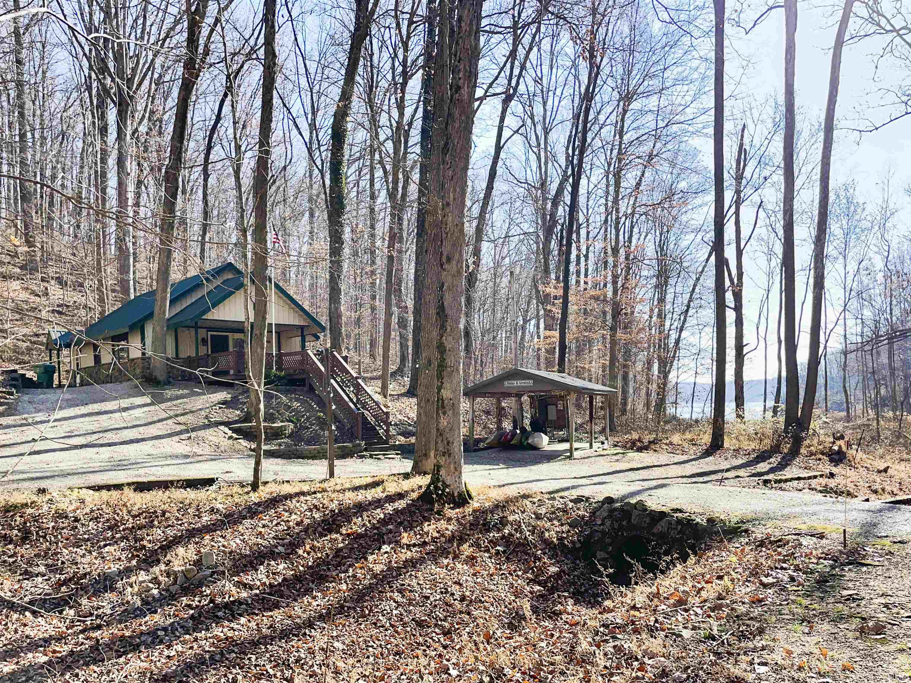 Prime Patoka Lake property with 9+ acres!  Enjoy year round fun at your own piece of paradise nestled in a secluded wooded valley with large mature trees, within eyesight of Patoka Lake and within a short walk to the shore.  Cabin provides all the conveniences of home and offers a cathedral ceiling entry, 2 Bedrooms + 2 additional sleeping quarters in the large loft, 1 full Bathroom, walk-in cedar closet, new HVAC installed in 2020, and laundry facilities included.  There's a large deck for entertaining, 12'x20' covered boat shed, 24'x30' insulated pole building with wood stove and window AC, and a newer 22'x30' metal boat storage shed. This is an outdoorsman's dream with with a fish cleaning station, permanent deer blind, deer hoist, 2 deer stands, and a established food plot all included.  Property is bordered by federal land which is able to be hunted.  Jackson boat ramp is just 10 min away.
