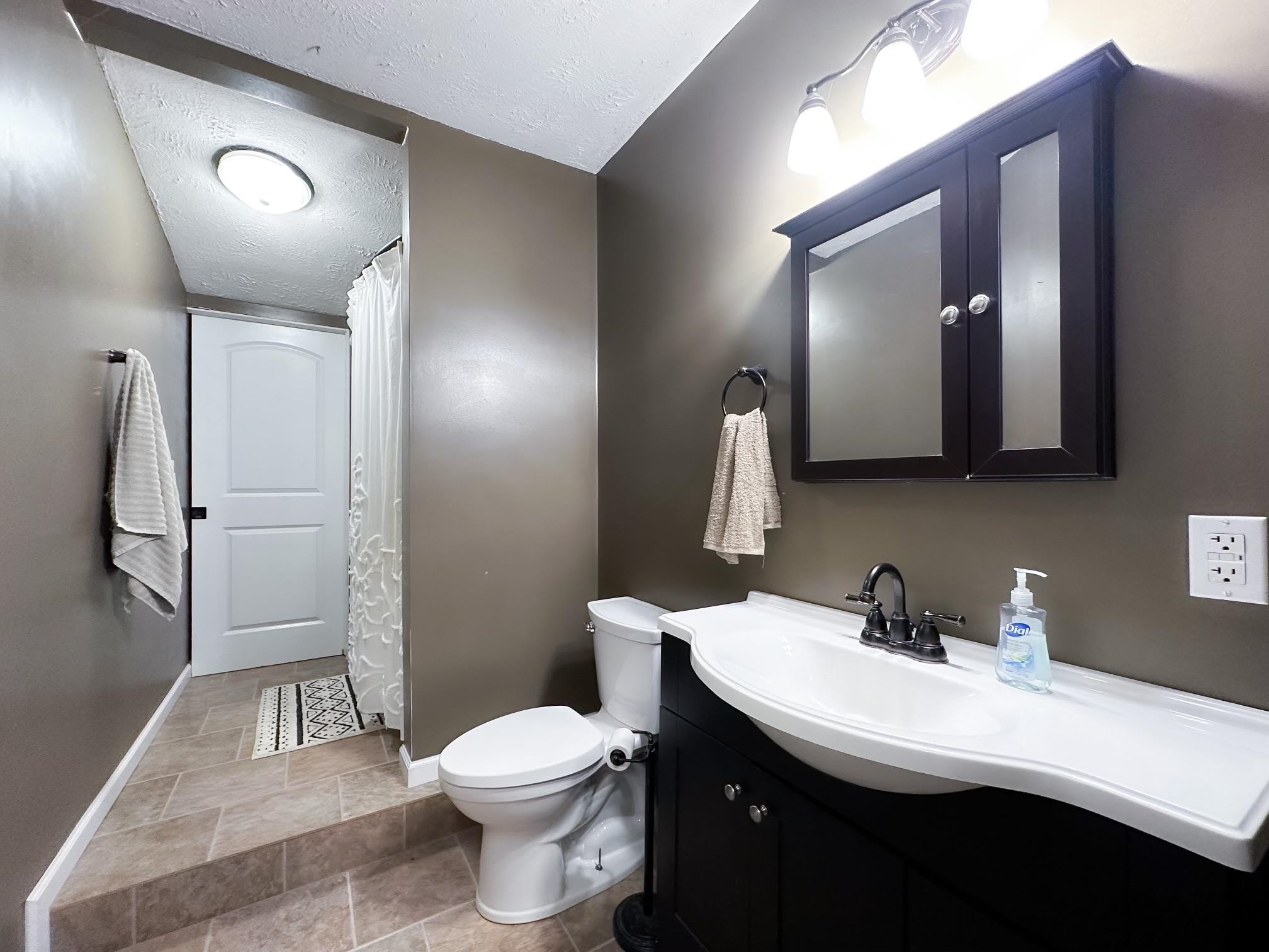 Bathroom near living room and laundry room