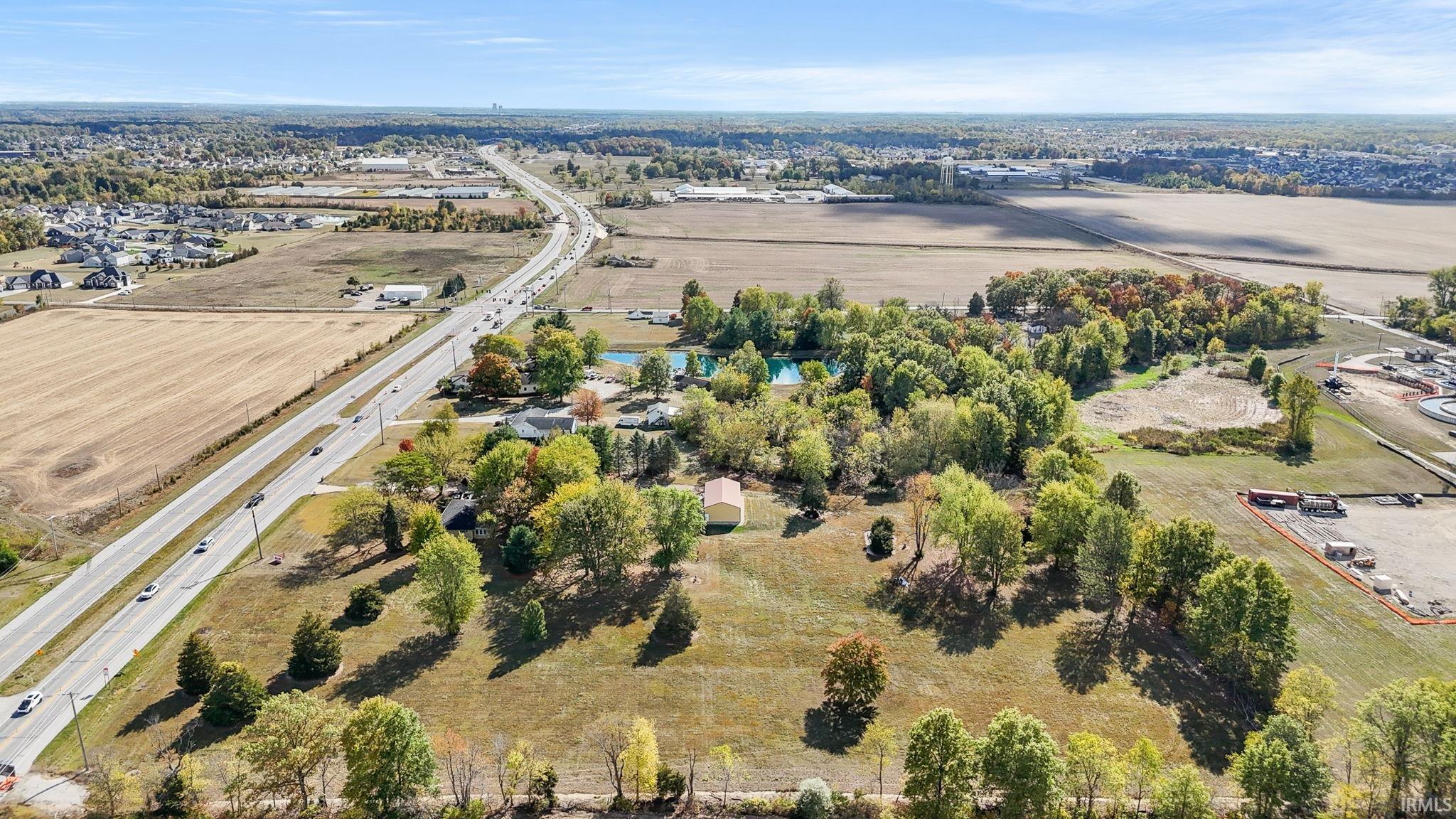 Aerial view of sparsely populated area featuring a major roadway