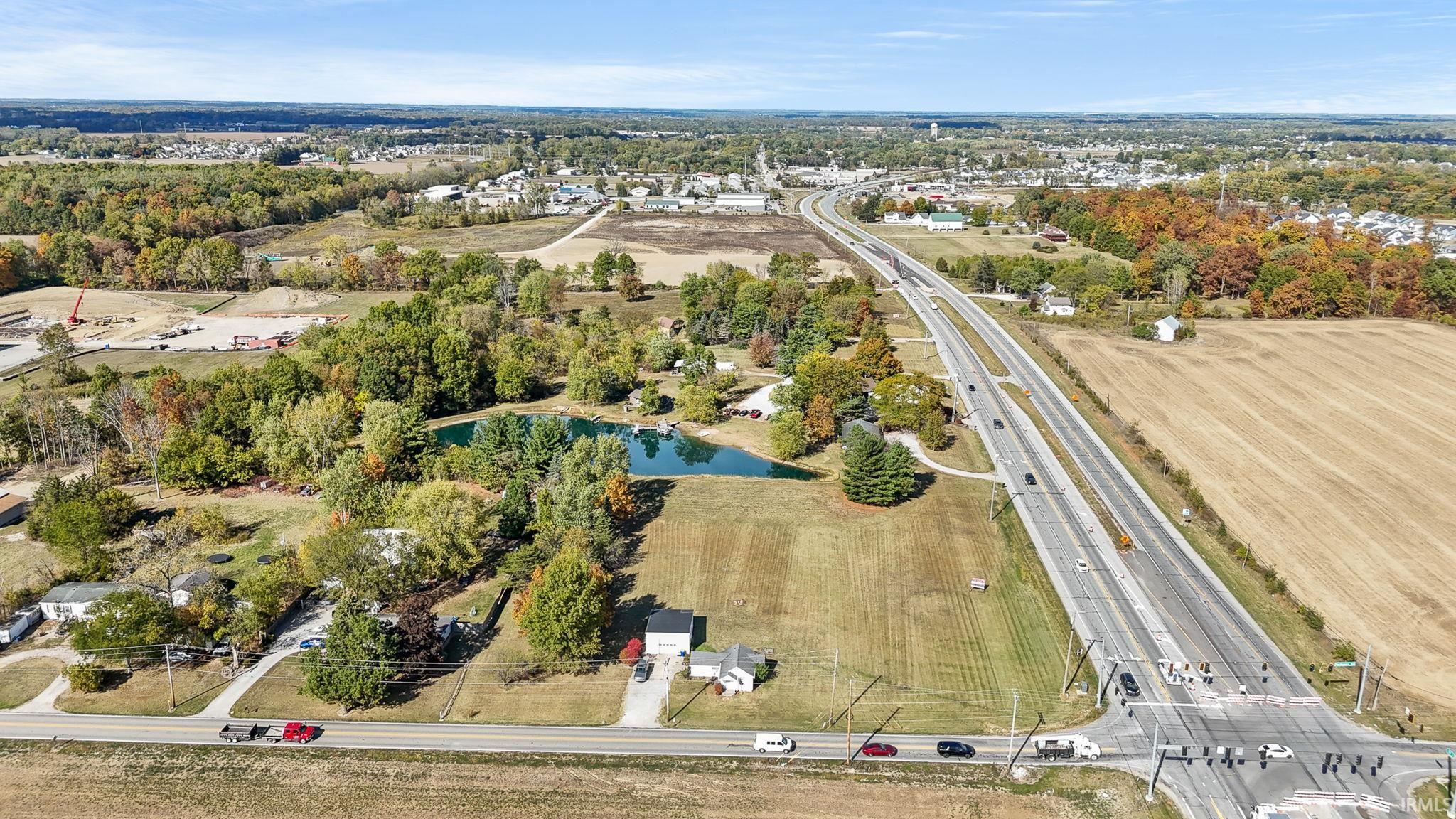 Aerial view of property's location featuring a nearby body of water and a major roadway