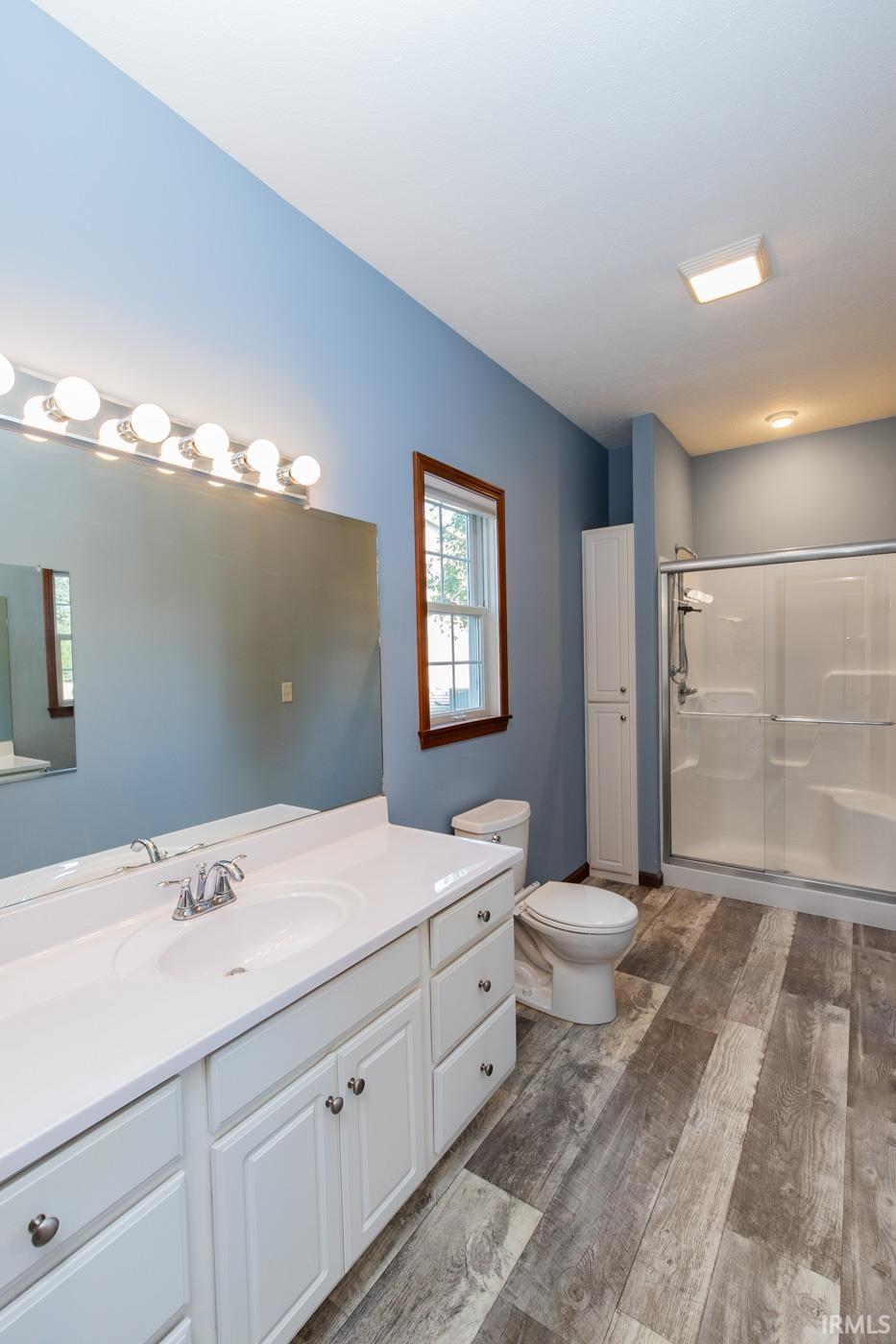 W/Large vanity and linen cab. in the corner.