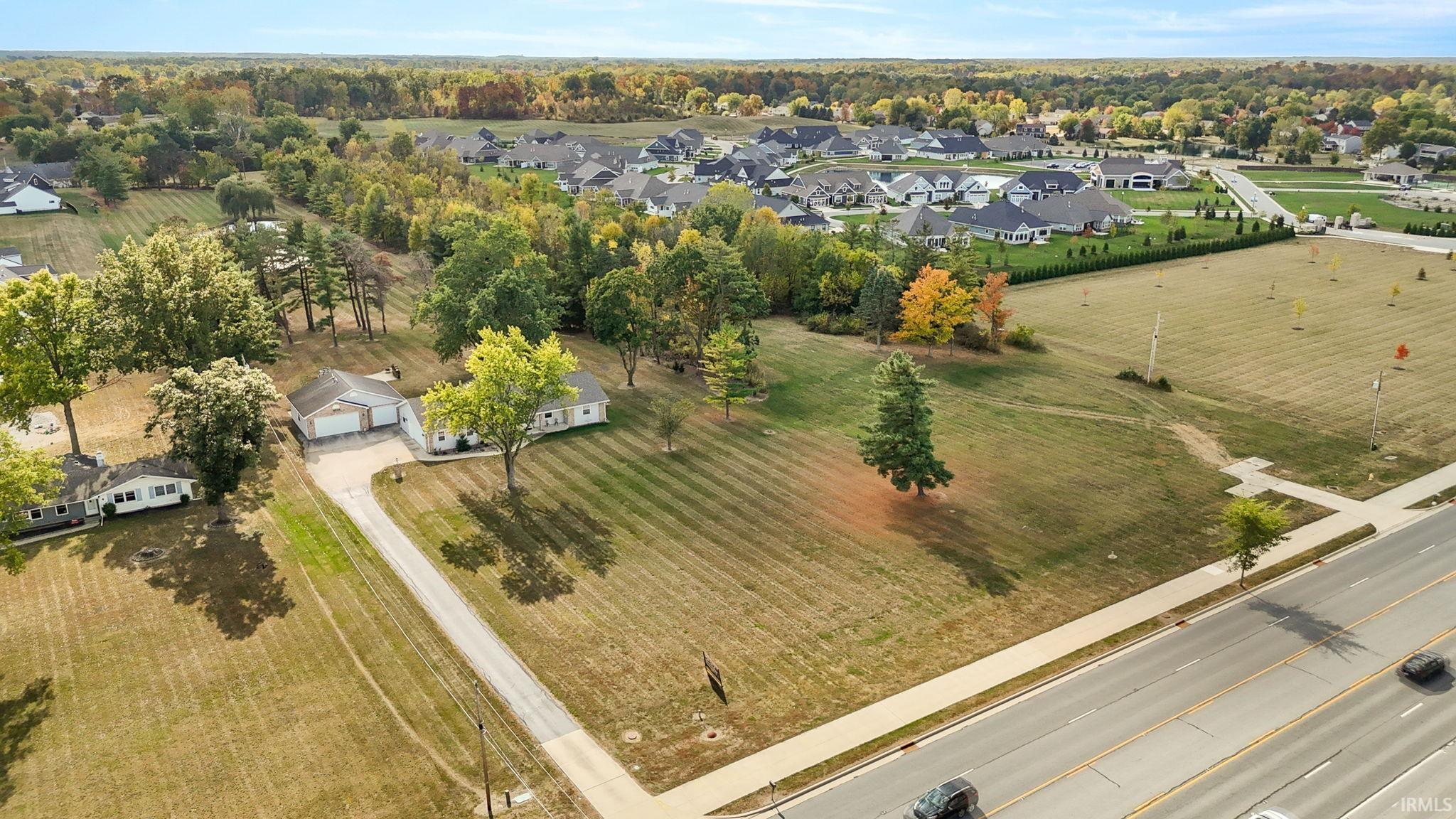 Aerial overview of property's location with nearby suburban area