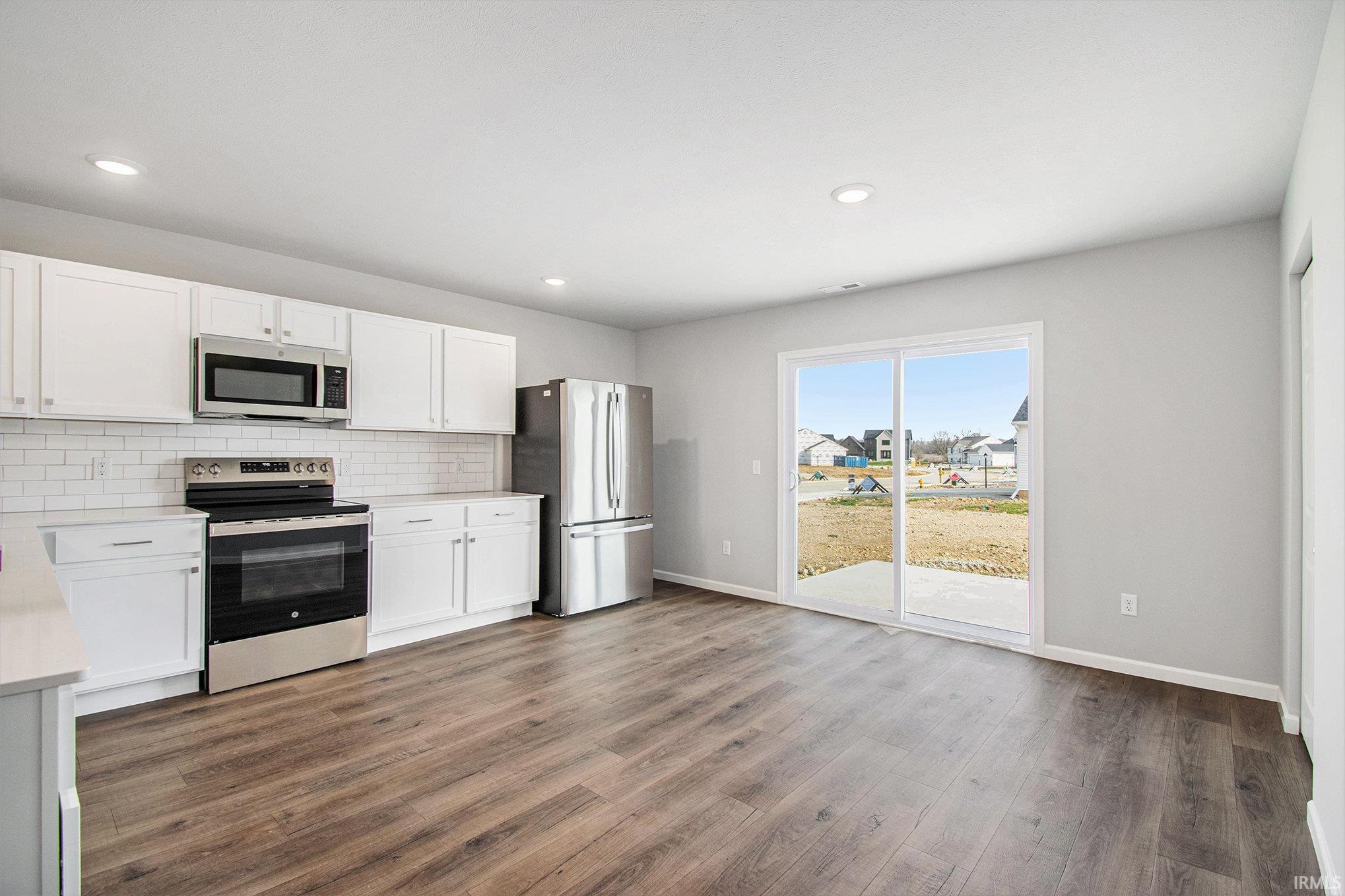 The dining nook can accommodate a large table and has direct access to the rear yard.