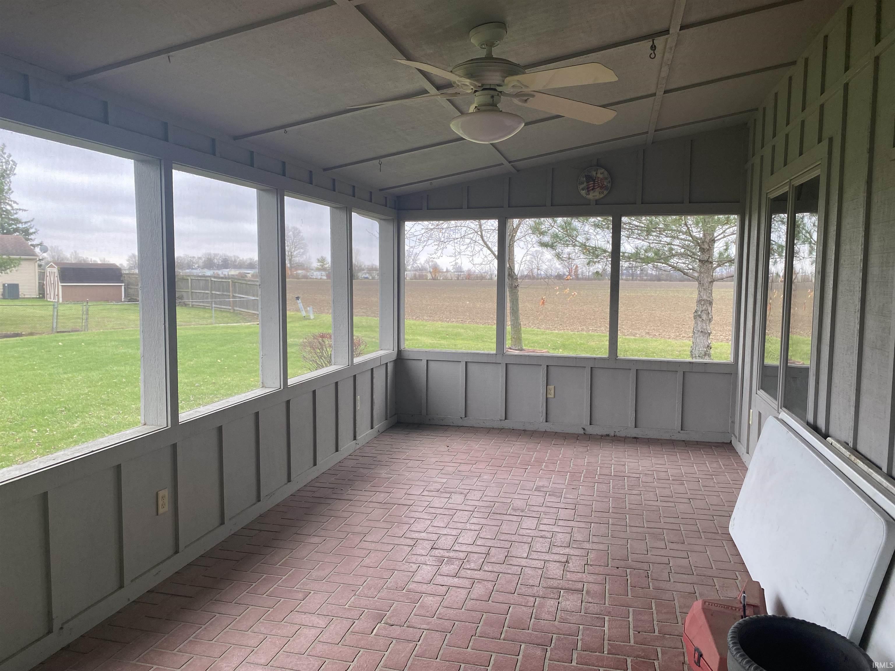 Enjoy your screened in porch on balmy evenings. Equipped with overhead fan, and a beautiful brick stamped concrete floor.