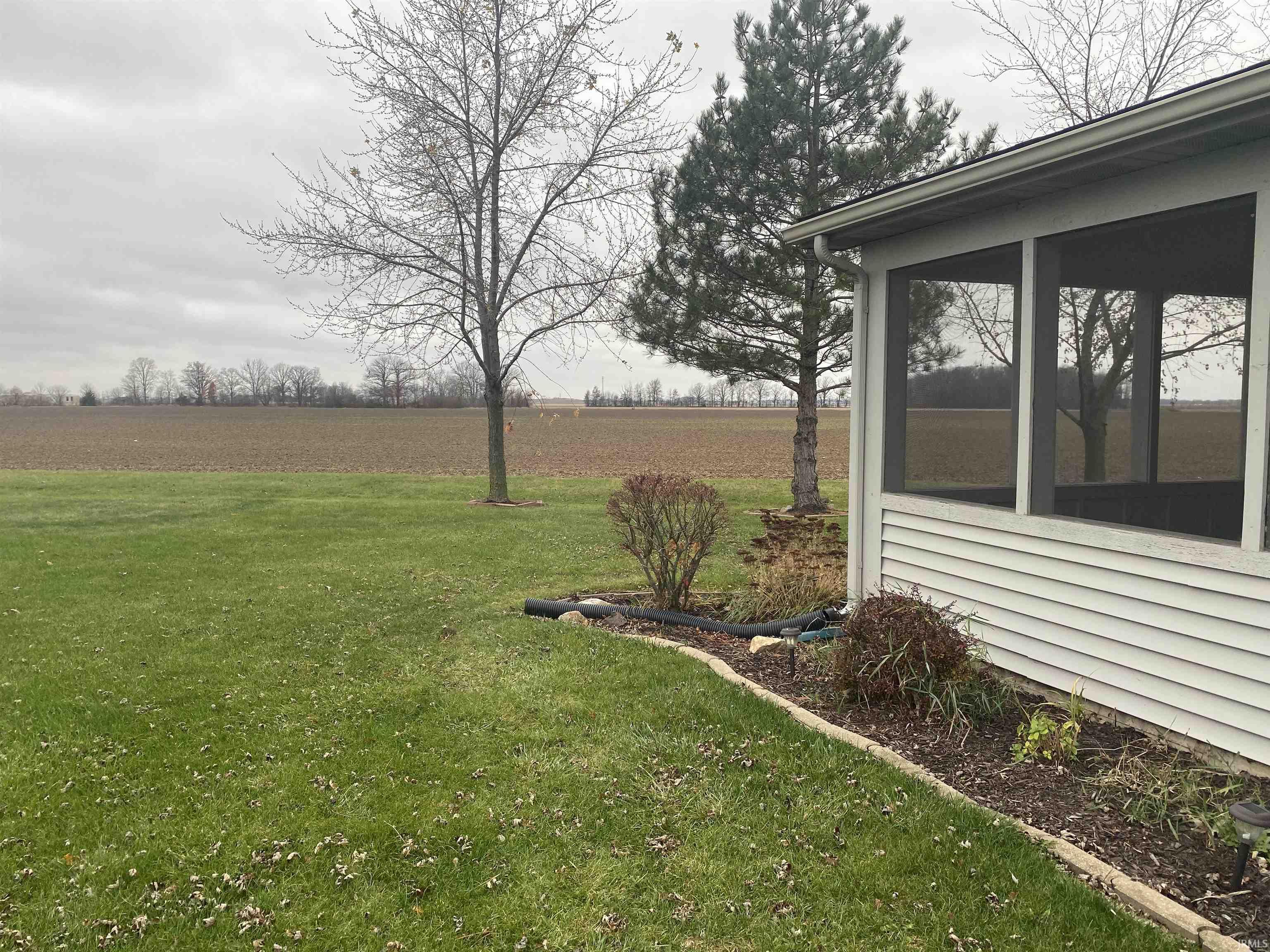 Rear view of back of property, Large culdesac lot, with no neighbors at your rear of property. Two above ground garden areas on north side of property, or till up rear property for a large garden.