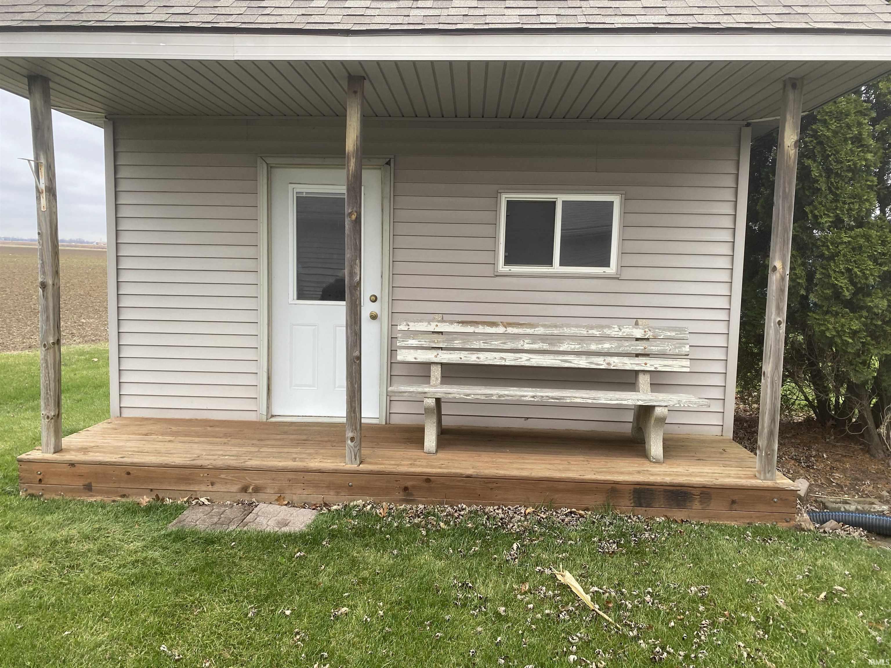 13 x 26 shed with upper story and stairway. Front porch for watching birds and animals. Equipped with electricity and work bench. Drive your tractor right in with rear overhead door.