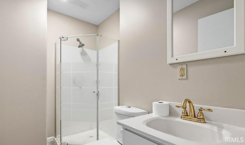 Full bath with vanity and a stall shower