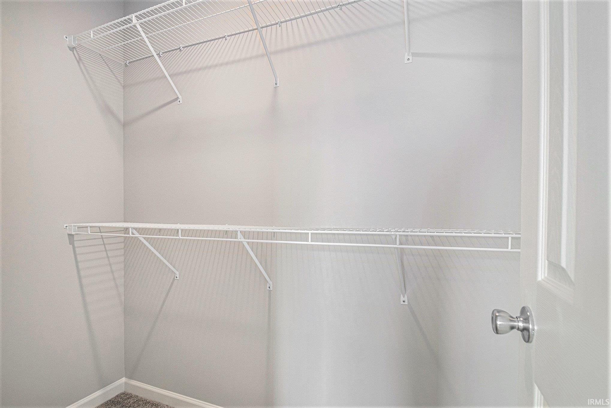 The primary suite features double exterior windows, a private bath with an exterior window and a large walk-in closet.