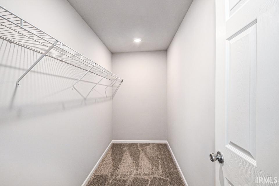 The spacious primary suite includes a private bath and oversized walk-in closet.