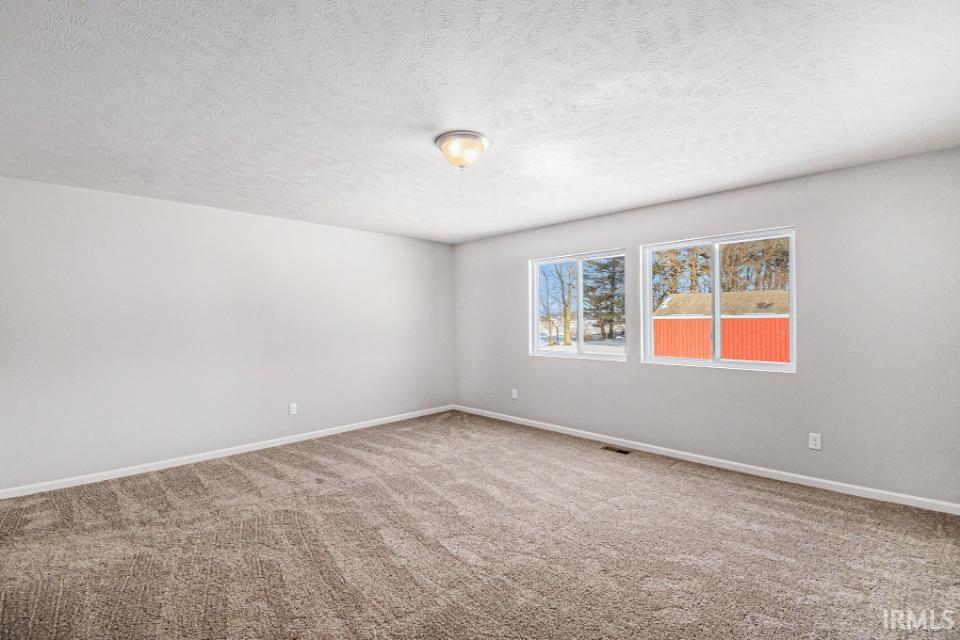 The spacious primary suite includes a private bath and oversized walk-in closet.