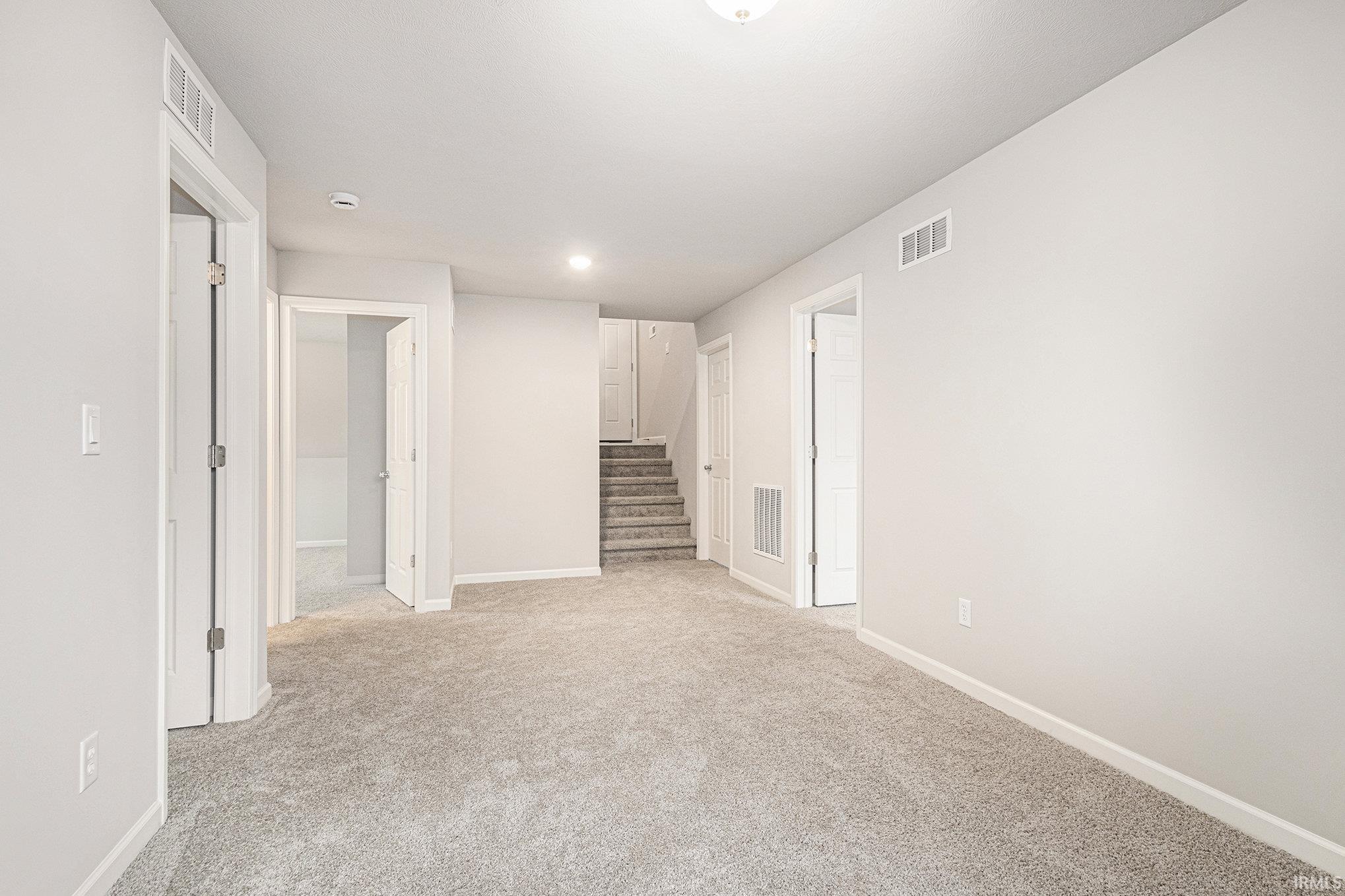 The lower-level Rec Room can be utilized as a gathering space, den or home office.