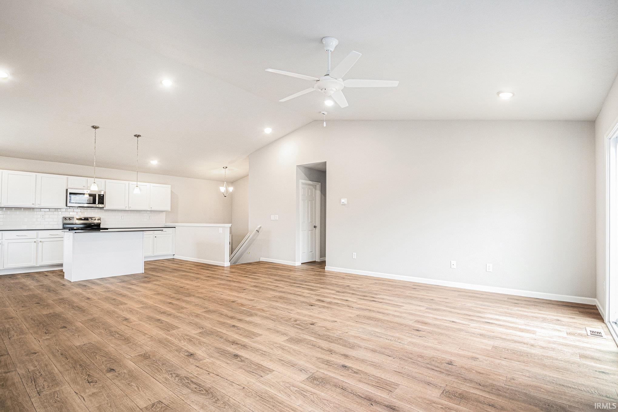 The great room & kitchen feature stunning vaulted ceilings with energy efficient fan and recessed lighting.  The flooring is consistent throughout the great room, kitchen & nook.  Enjoy outdoor dining & entertaining on the 10x10 deck