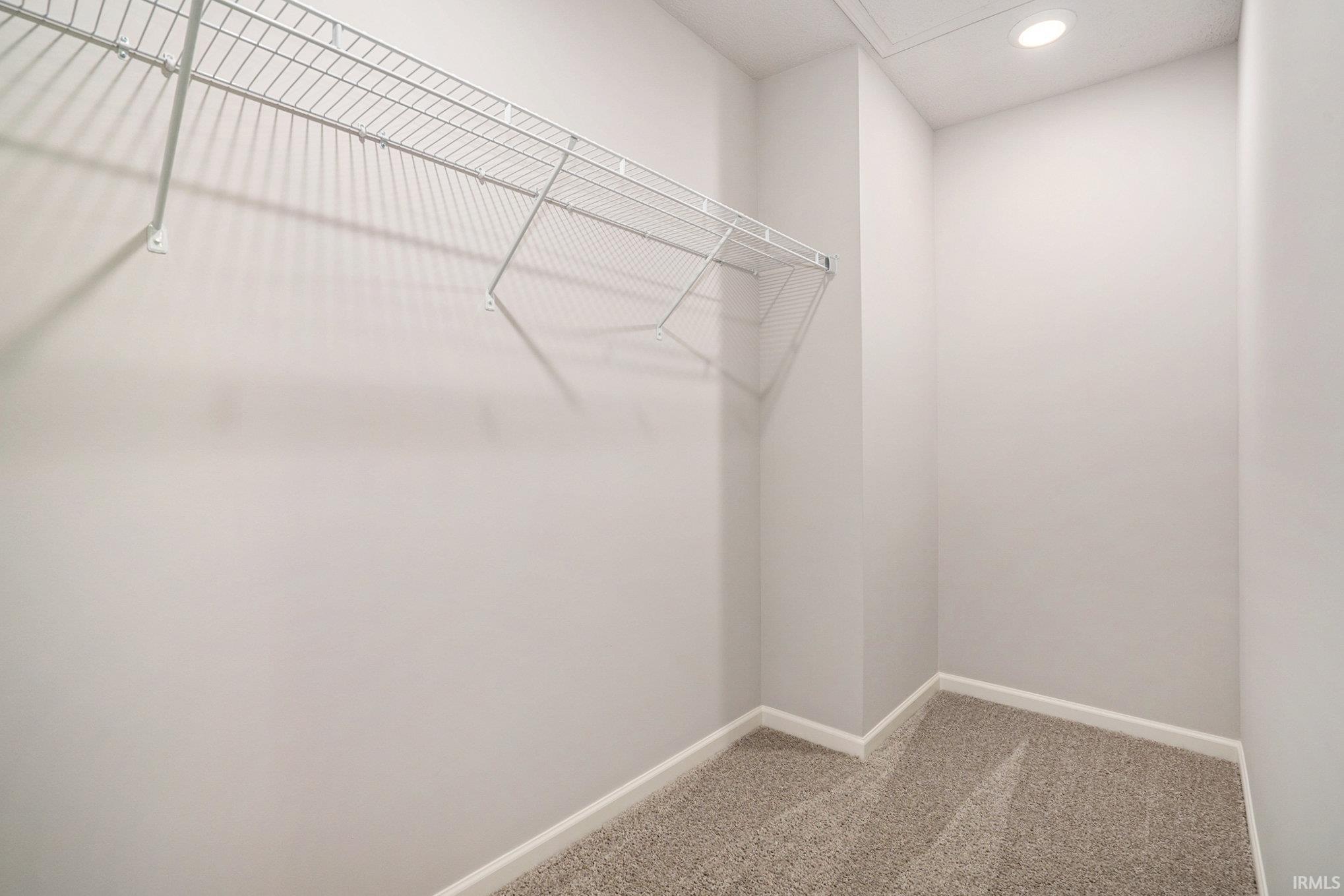 The primary suite is located on the upper level and includes a private bath and oversized walk-in closet.