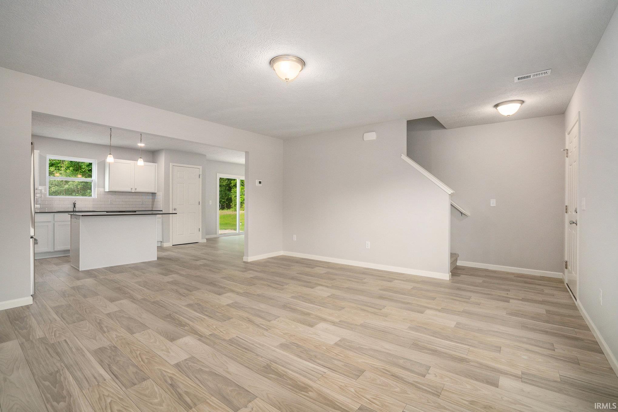 This home welcomes into a spacious great room which features an abundance of natural lighting and consistent flooring throughout the great room, kitchen & nook allowing seamless flow between the rooms.